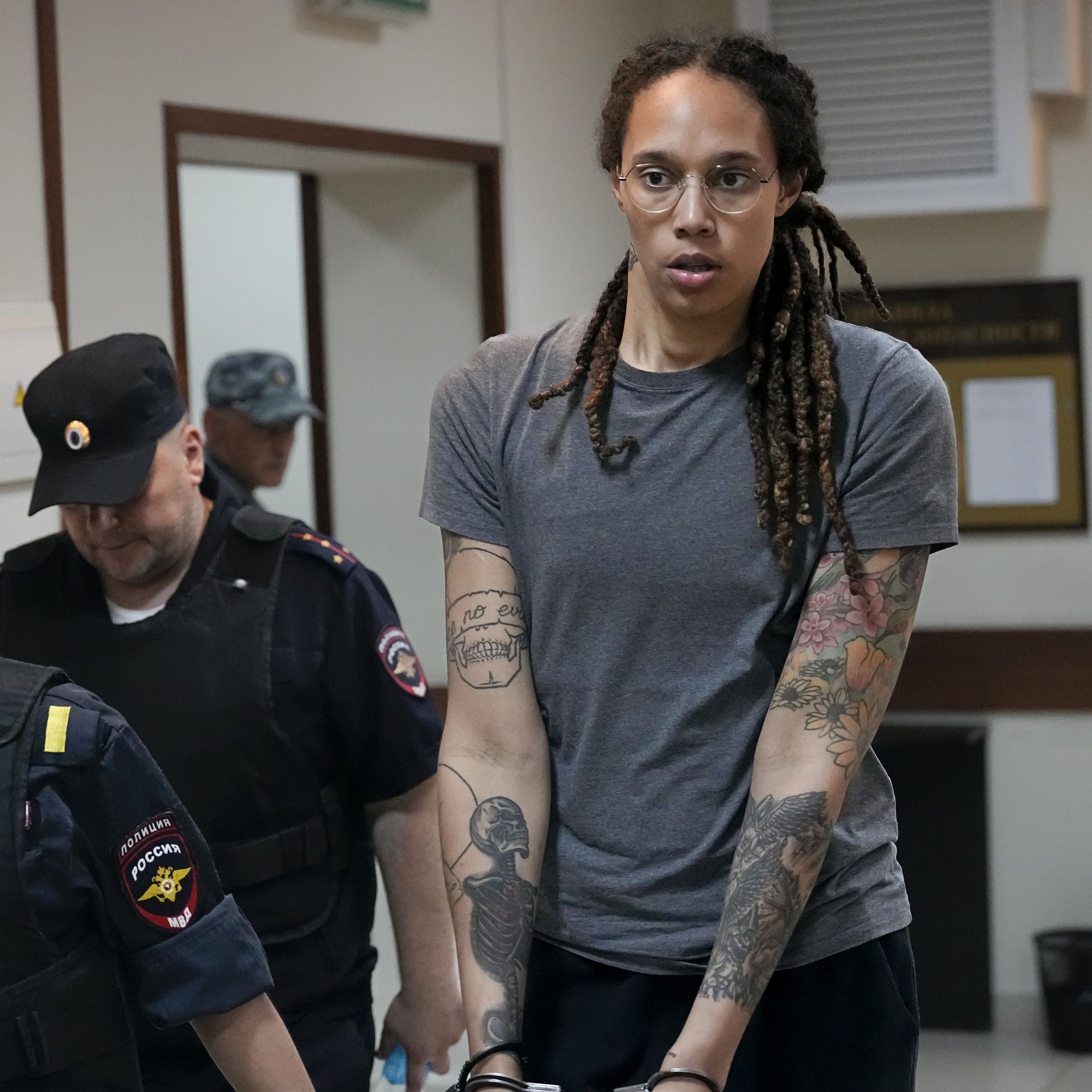 Guards escort Brittney Griner from a Russian courtroom