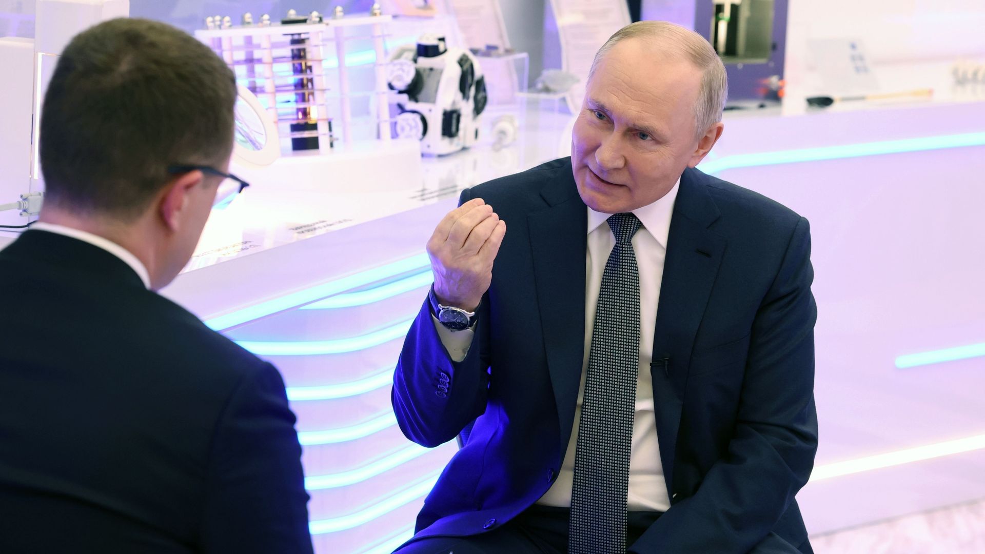 Russian President Vladimir Putin speaks to a television reporter.