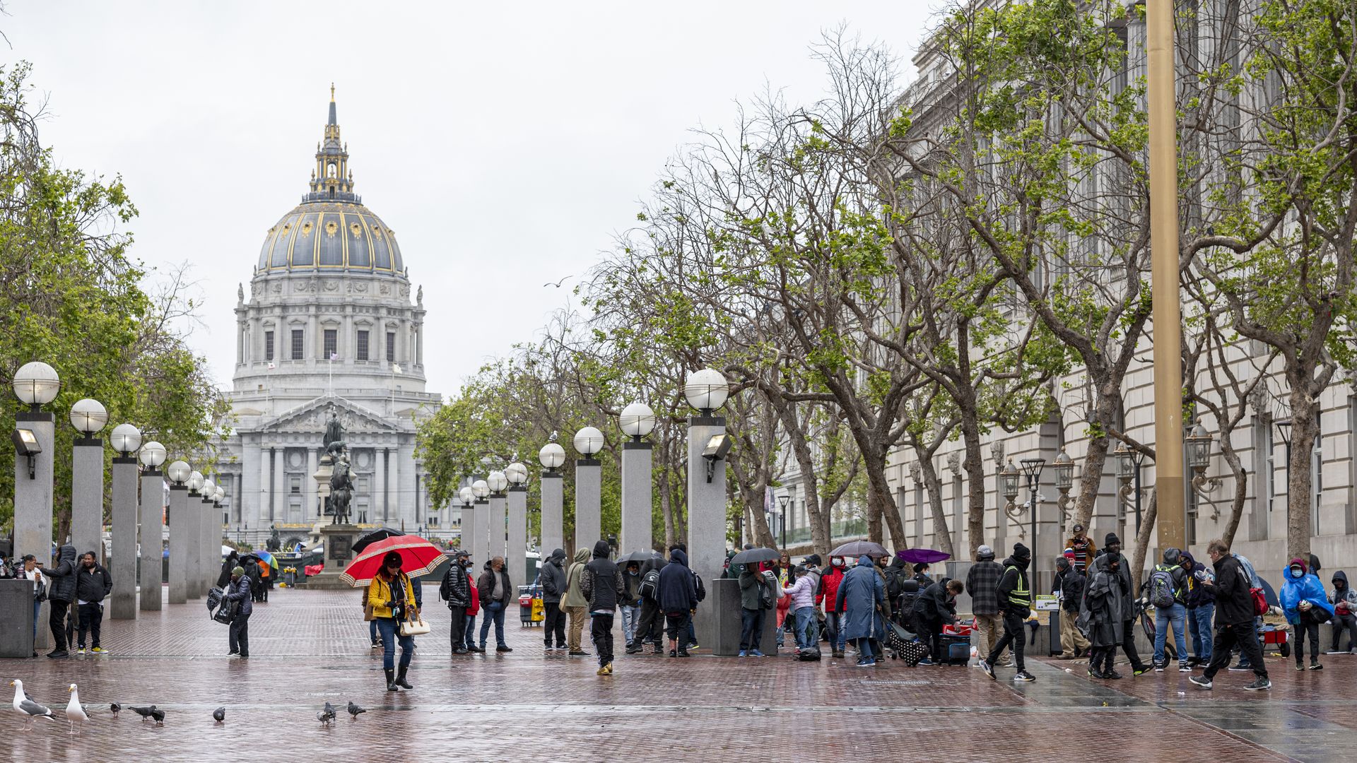 Photo of the front exterior of the San Francisco City Hall with people gathered in the front