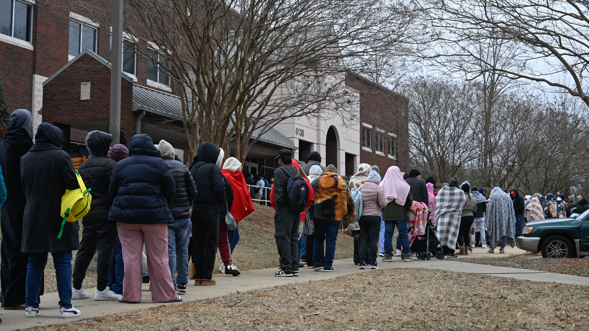 Immigrants wait outside an ICE center in Charlotte, N.C.
