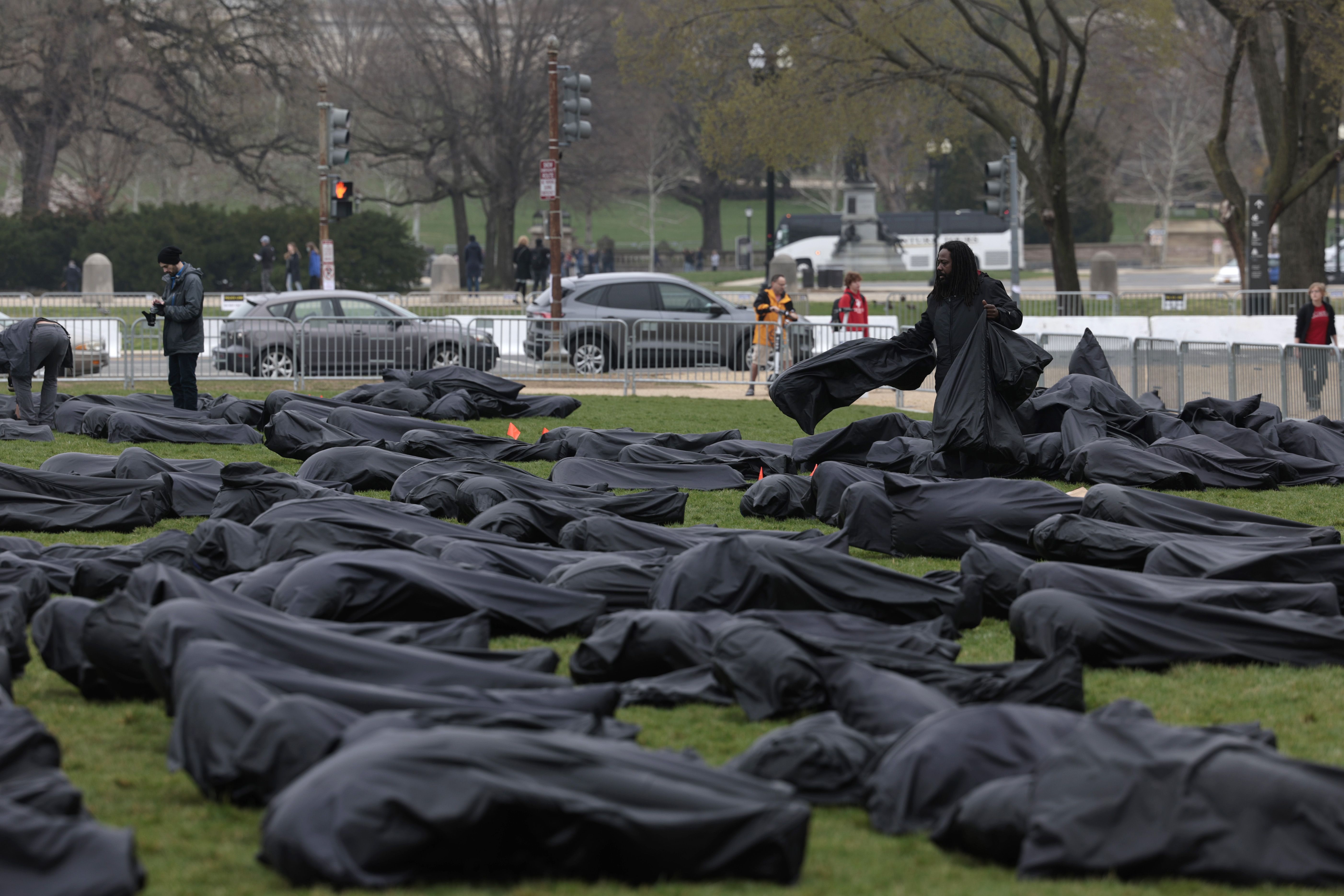 Volunteers assemble body bags on the National Mall by gun control activist group March For Our Lives on March 24, 2022 in Washington, DC. 