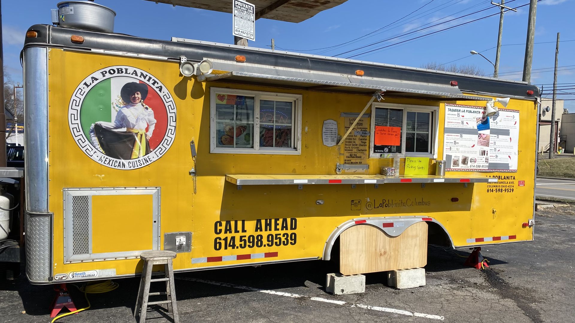 A yellow food truck with the La Poblanita logo on it