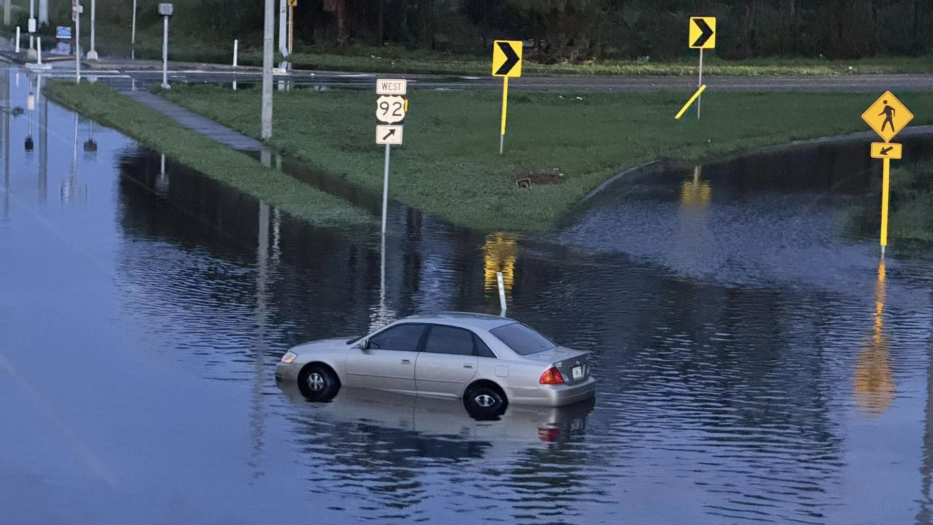 A view of a partially submerged car after Hurricane Milton caused severe flooding near Hillsborough Ave and Dale Mabry in Tampa, Florida.