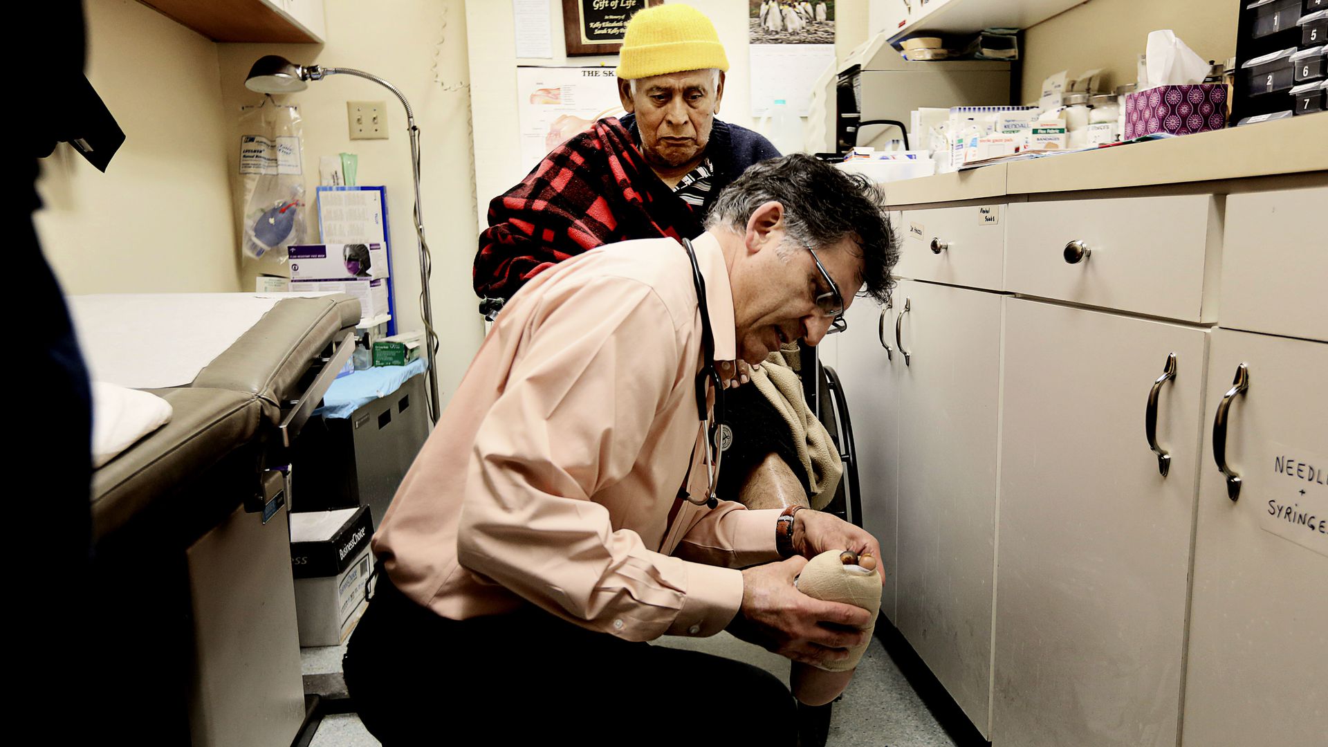 doctor evaluating patient in an exam room