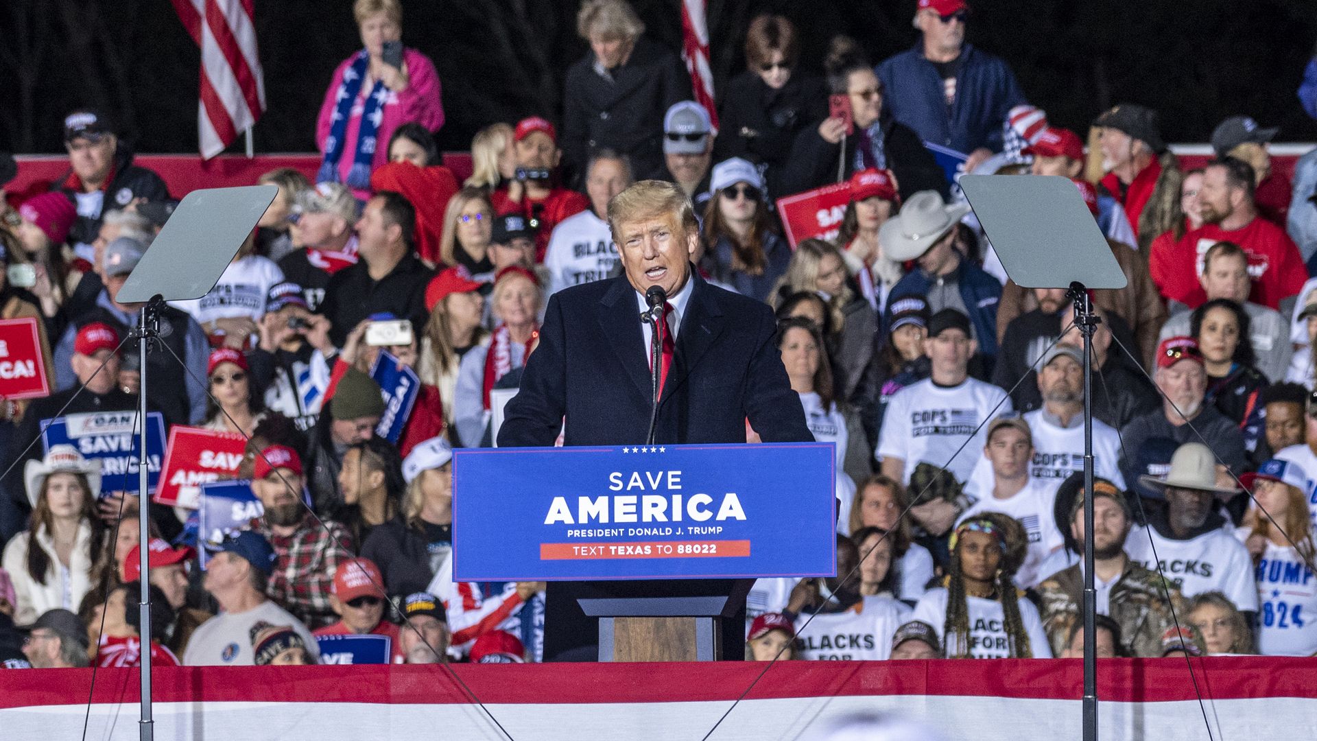 Former President Donald speaks to a crowd a rally