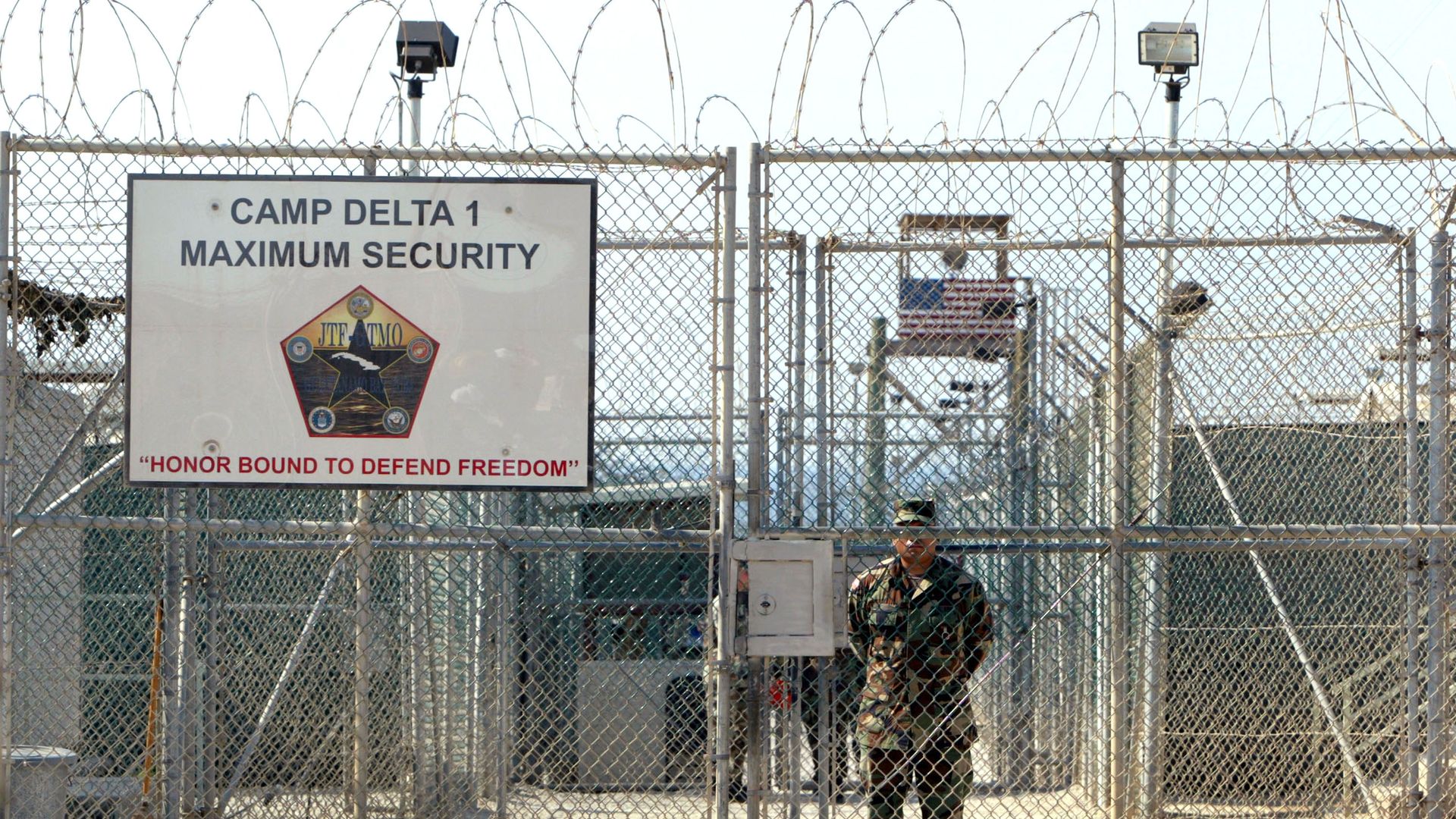 A U.S. Army soldier stands at the entrance to Camp Delta where detainees from the U.S. war in Afghanistan live April 7, 2004, in Guantanamo Bay, Cuba.