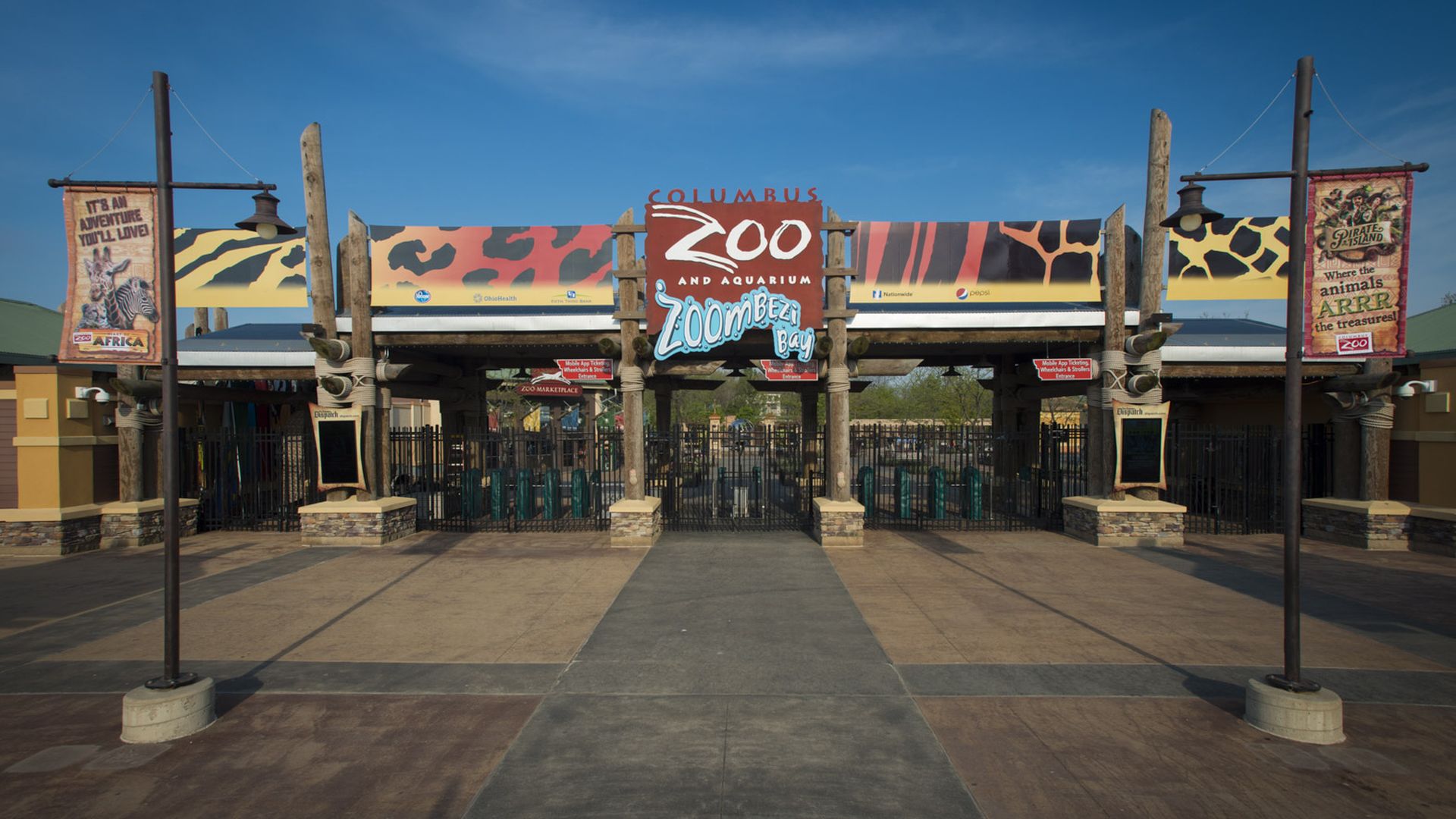 The entrance of the Columbus Zoo and Aquarium, with a sign covered in animal print