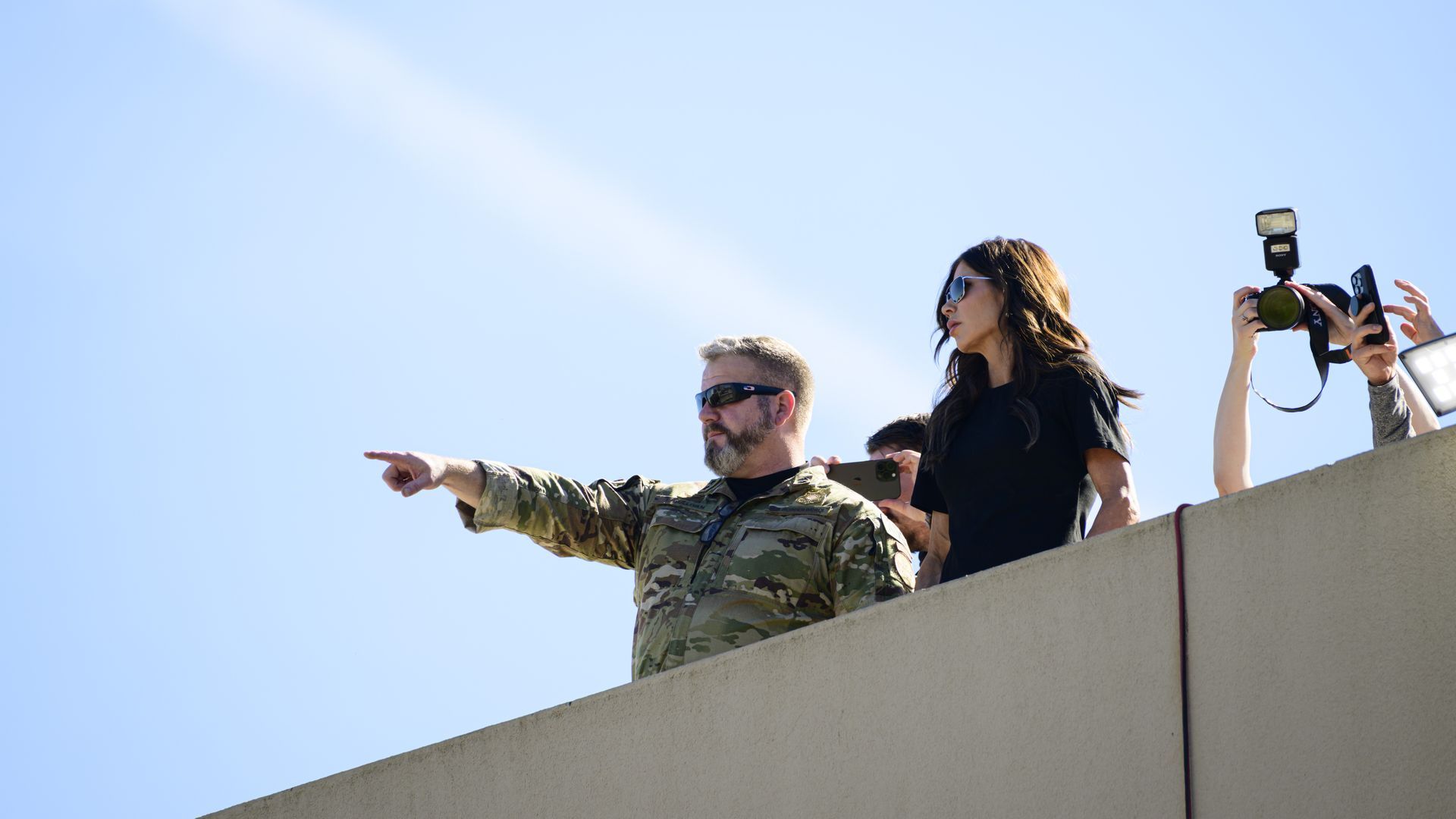 U.S. Homeland Security Secretary Kristi Noem observes the scene of ongoing protests at the Immigration and Customs Enforcement (ICE) facility on October 7, 2025 in Portland, Oregon.
