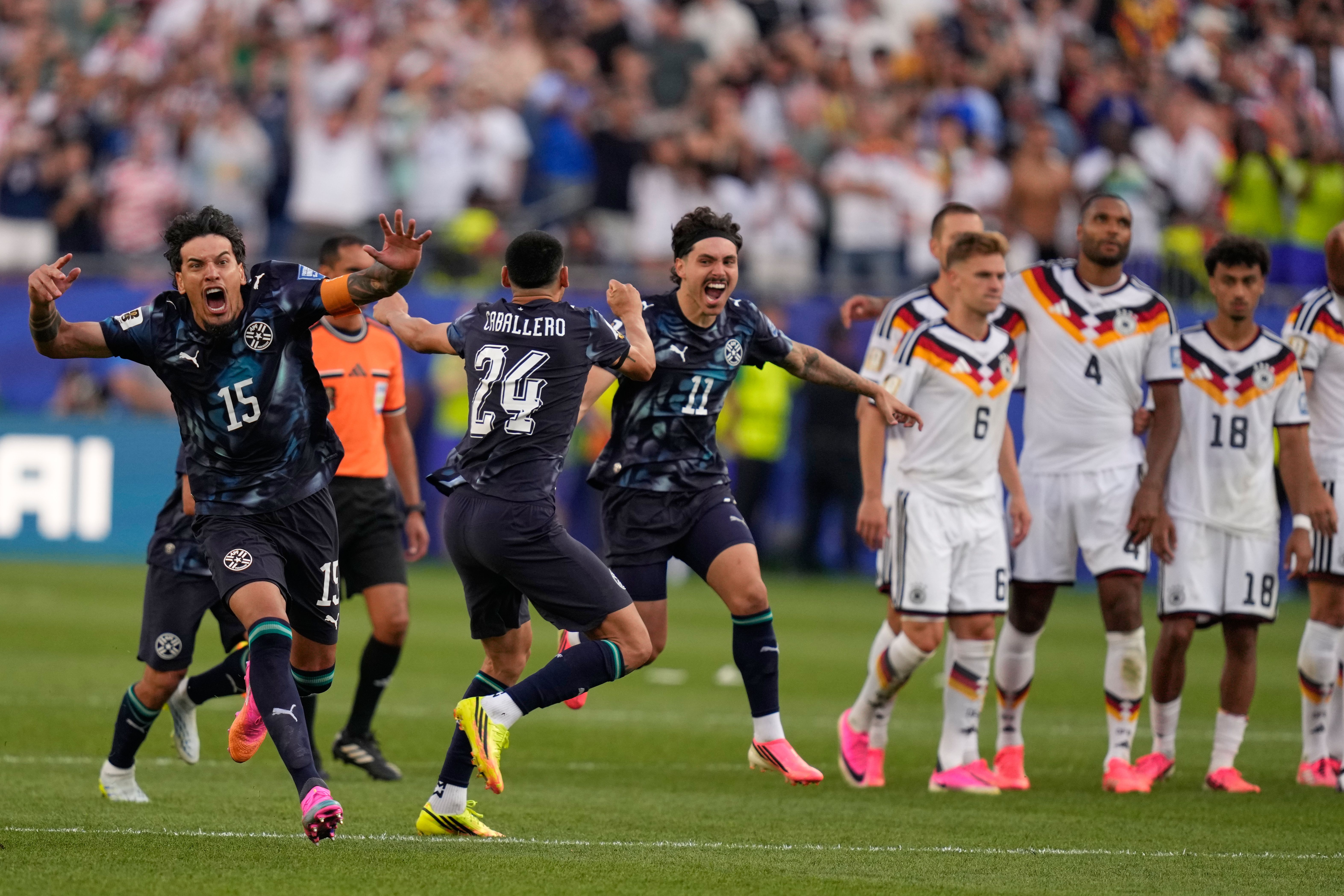 Paraguay players celebrate after defeating Germany in penalty shots to advance to the World Cup round of 16 yesterday.