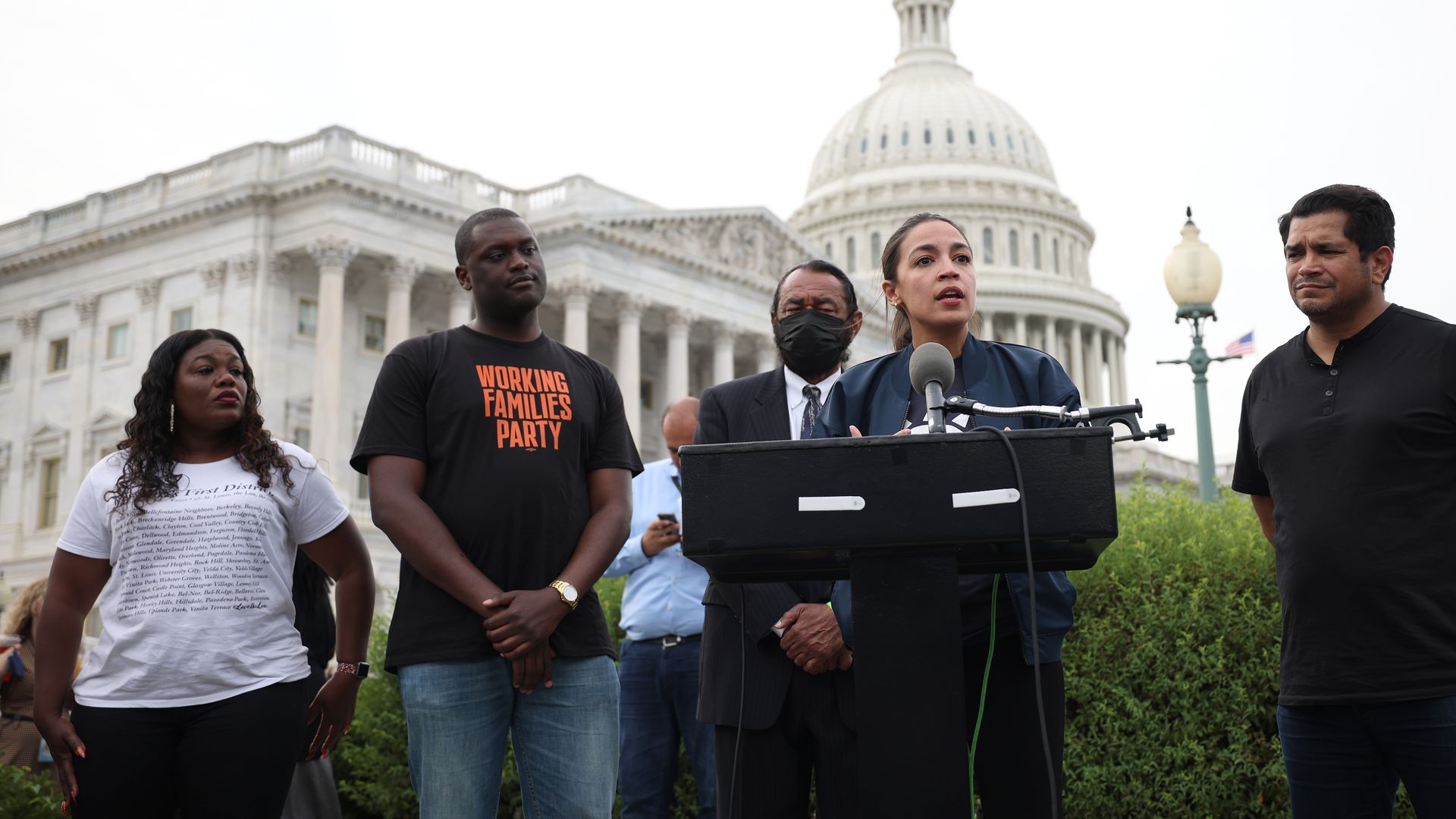 Rep. Mondaire Jones is seen looking on as his colleague Alexandria Ocasio-Cortez speaks outside the Capitol.