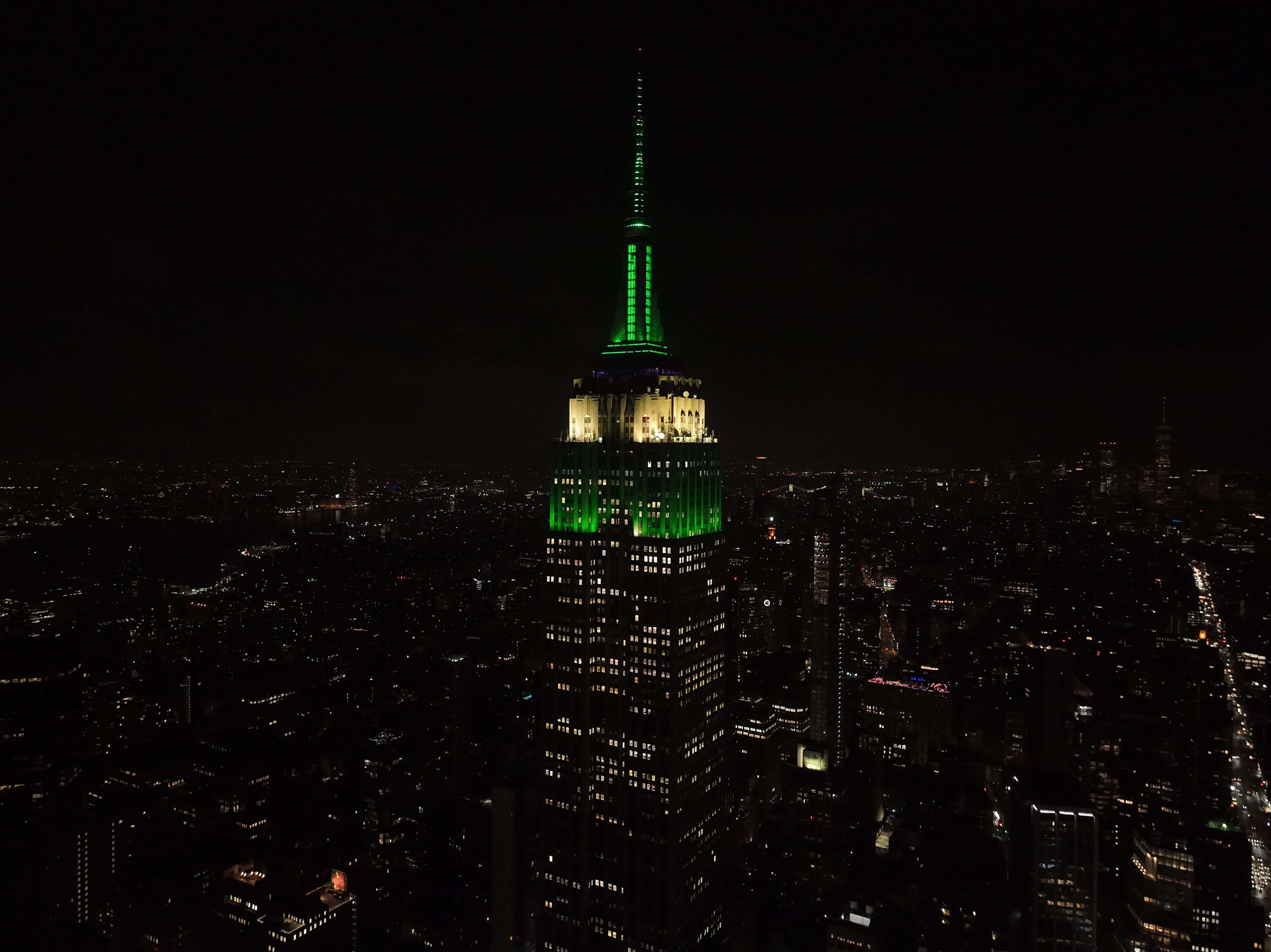Empire State Building lit up green.