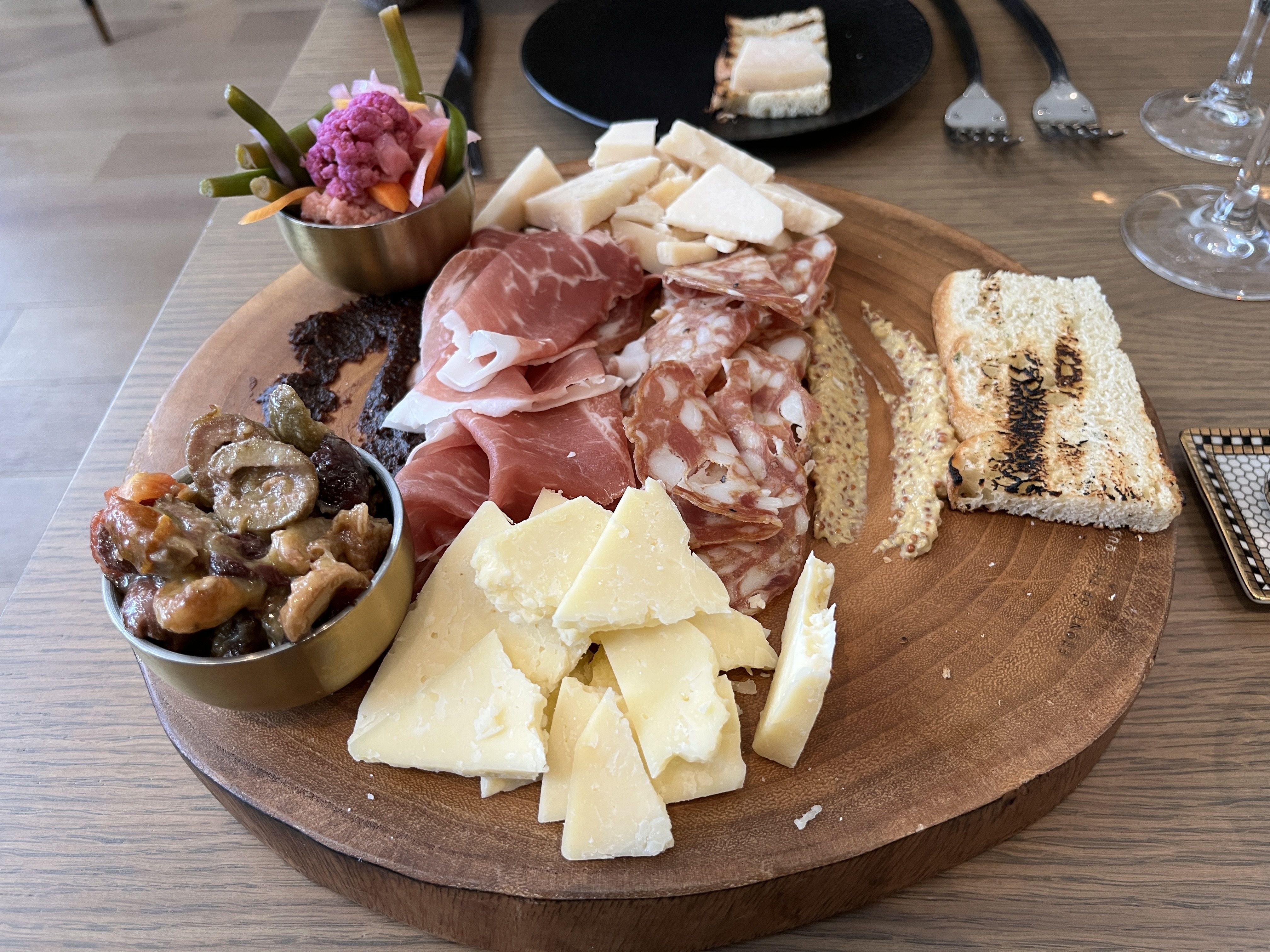 Antipasto plate stocked with meats, cheeses, giardiniera, fig jam and focaccia 