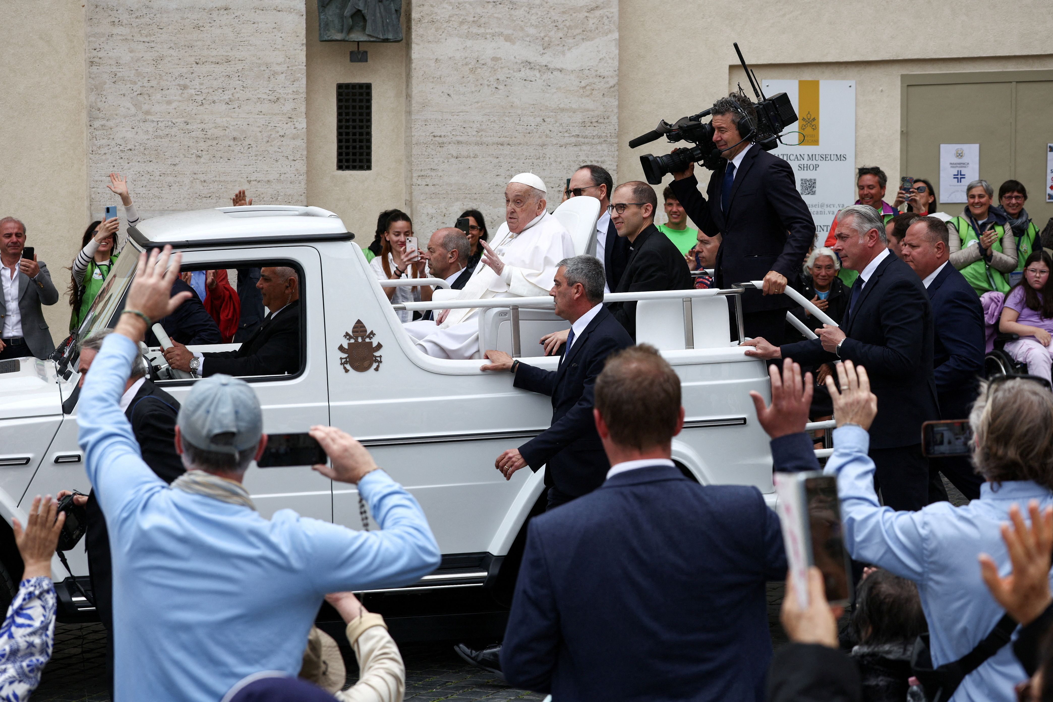 Pope Francis rides on the Popemobile at the Vatican yesterday. Photo: Guglielmo Mangiapane/Reuters
