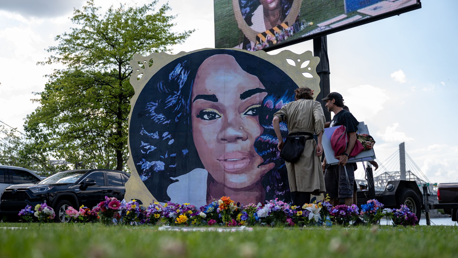Photo of a mural of Breonna Taylor propped up on a grassy lawn