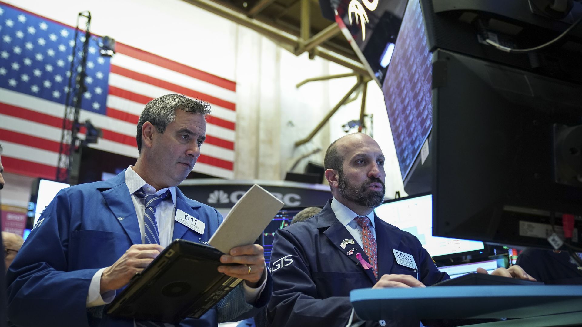 Traders look at a computer on the floor of the new york stock exchange