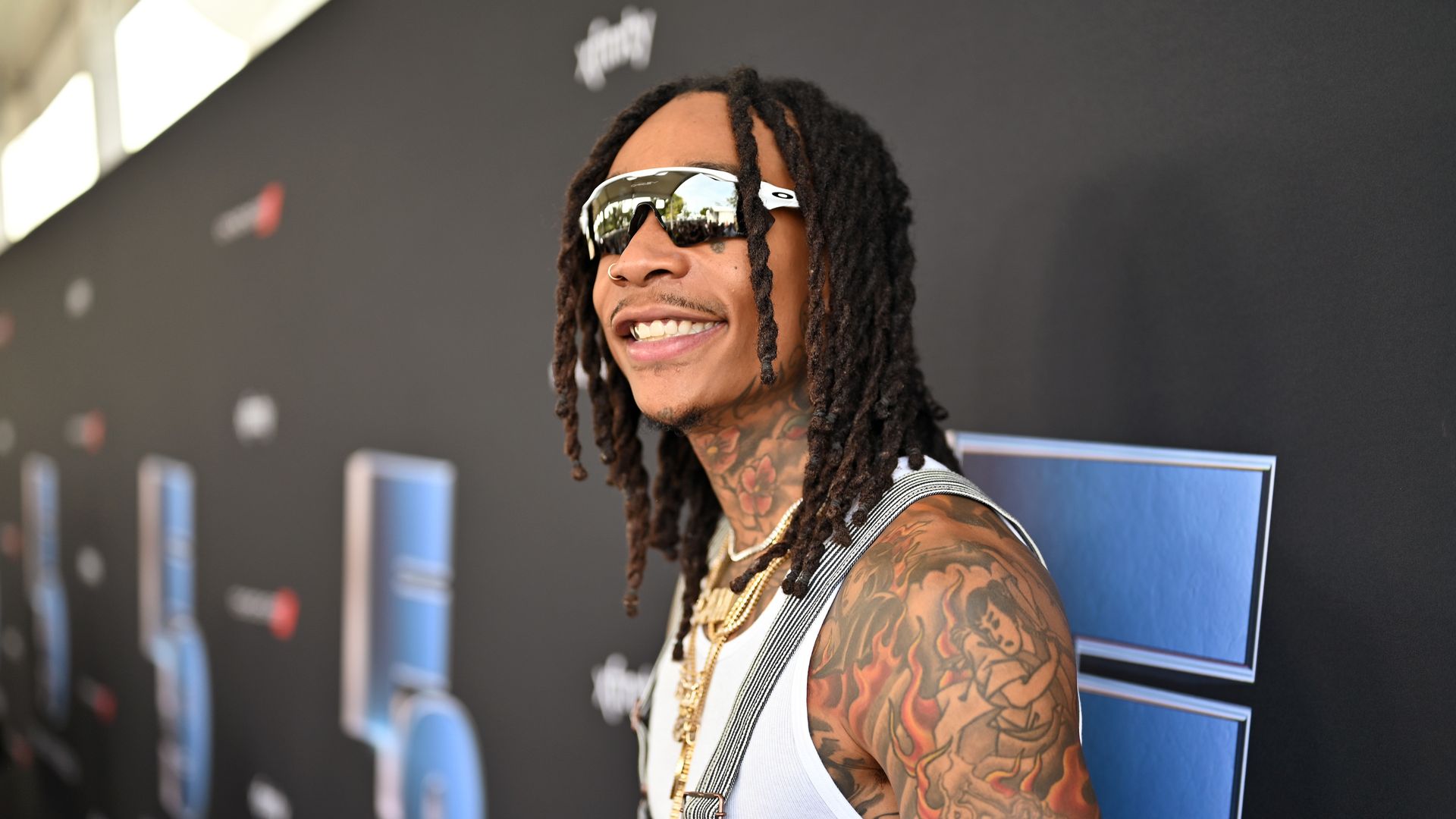 Rapper Wiz Khalifa smiles at a press event.