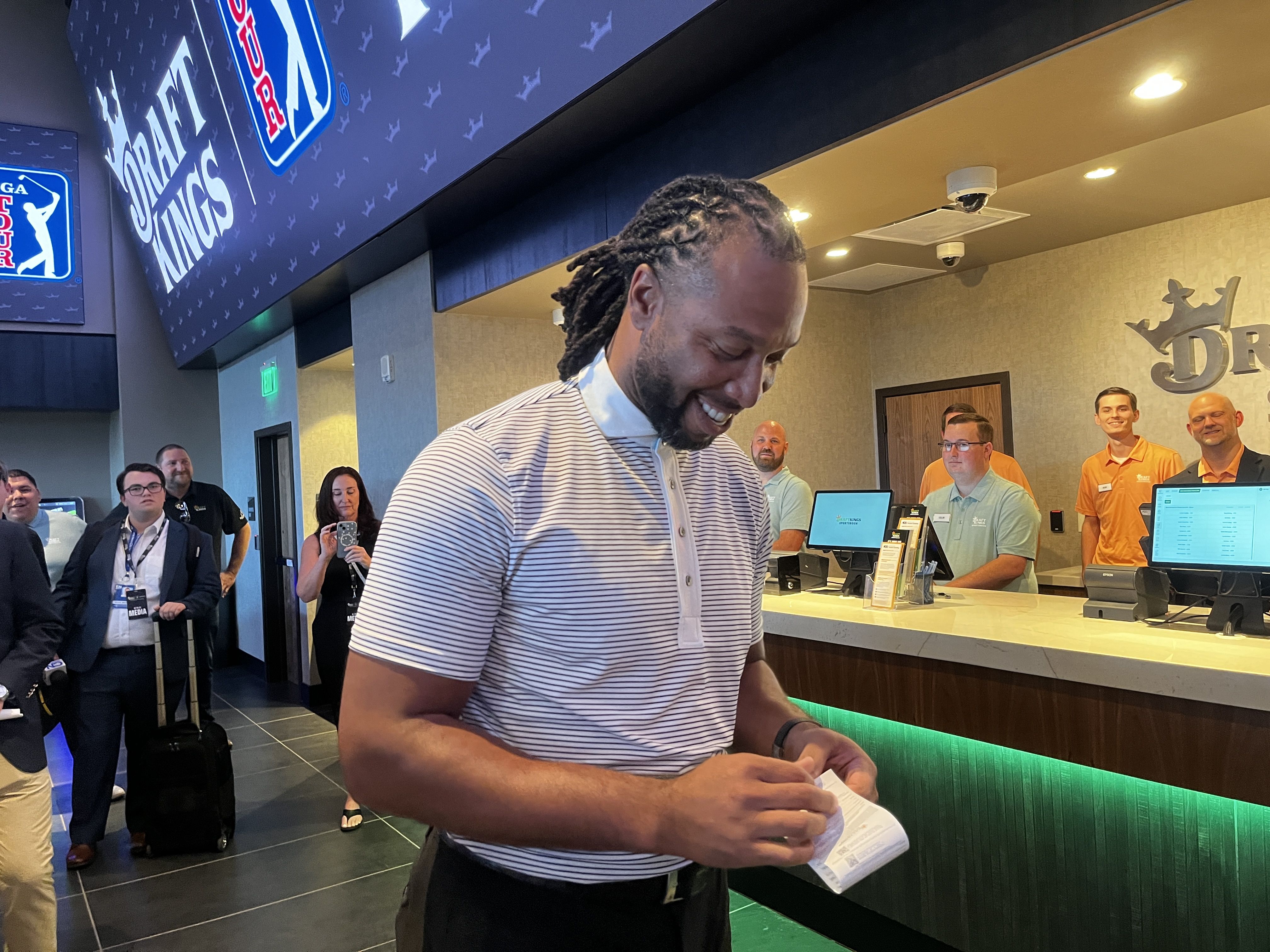 A man holding a bet slip.