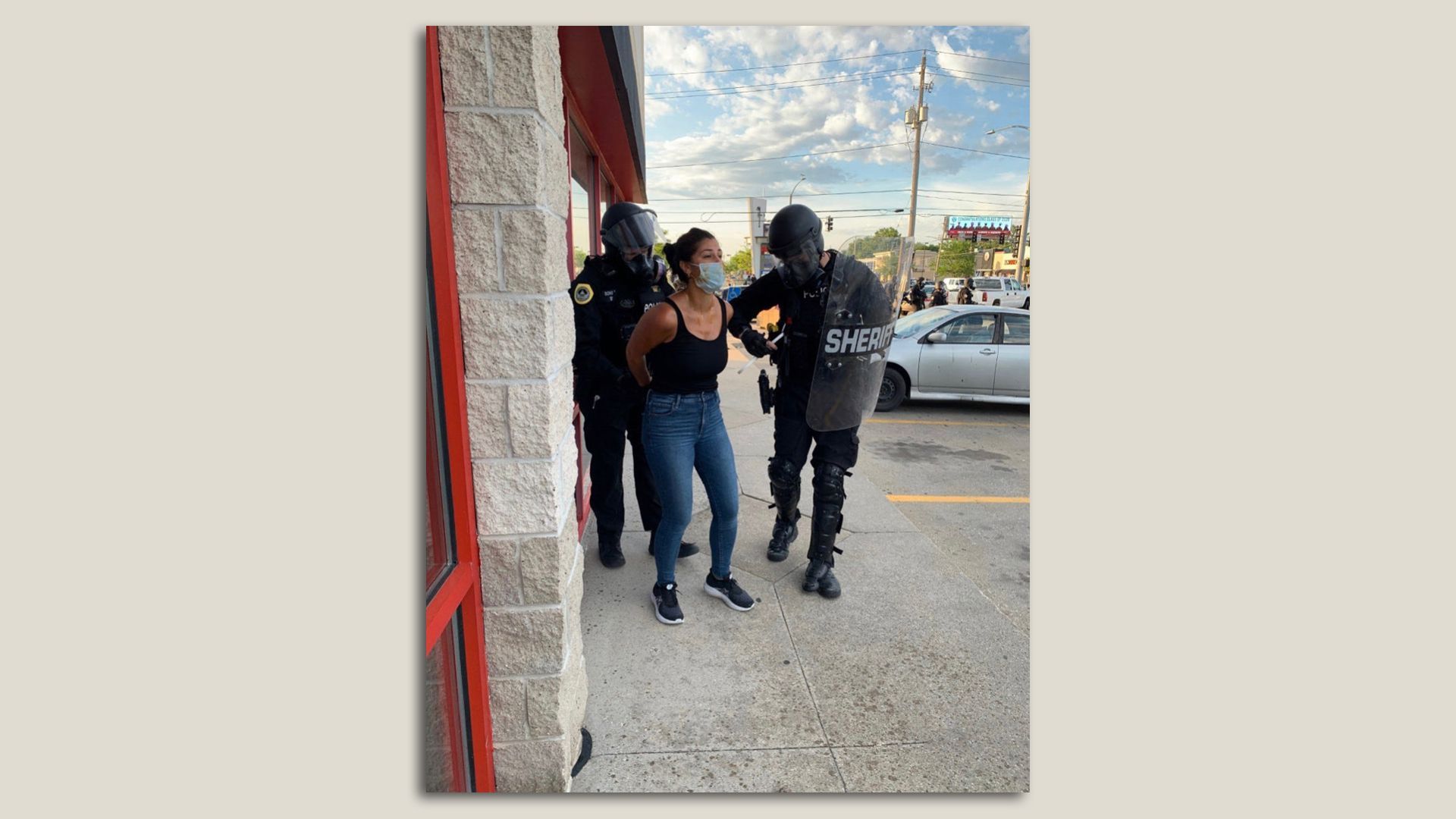 Des Moines police arrest reporter Andrea Sahouri outside Merle Hay Mall. Photo courtesy of Andrea Sahouri