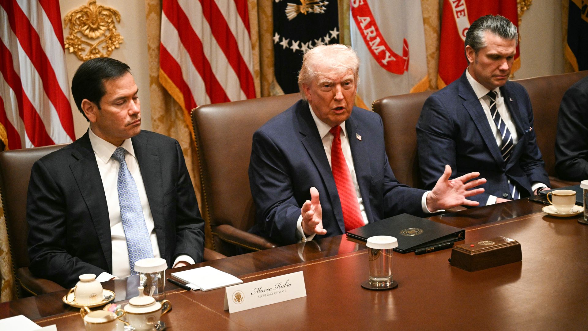 US President Donald Trump, flanked by Secretary of State Marco Rubio (L) and Defense Secretary Pete Hegseth (R), speaks during a cabinet meeting in the Cabinet Room of the White House in Washington, DC, on March 26, 2026. 