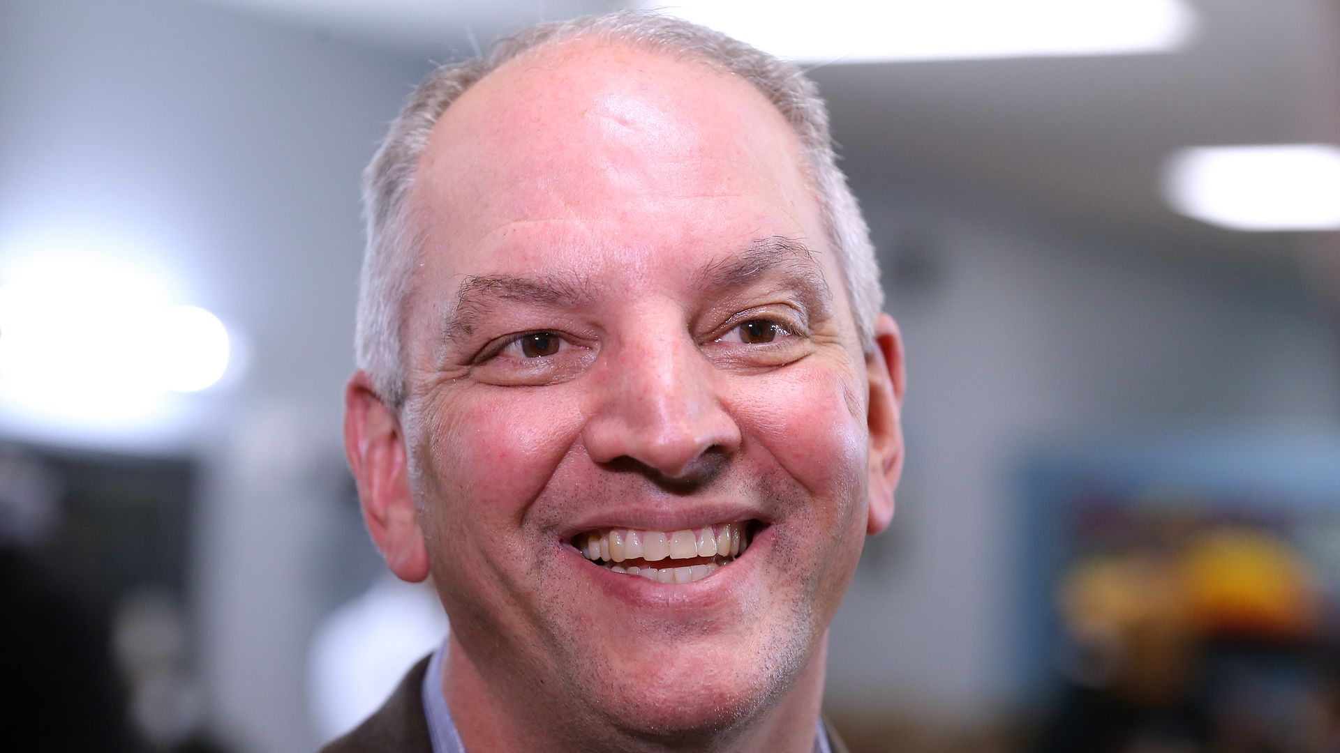 Gov. John Bel Edwards talks to media at the Case Closed Barbershop on Nov. 15  in New Orleans. 