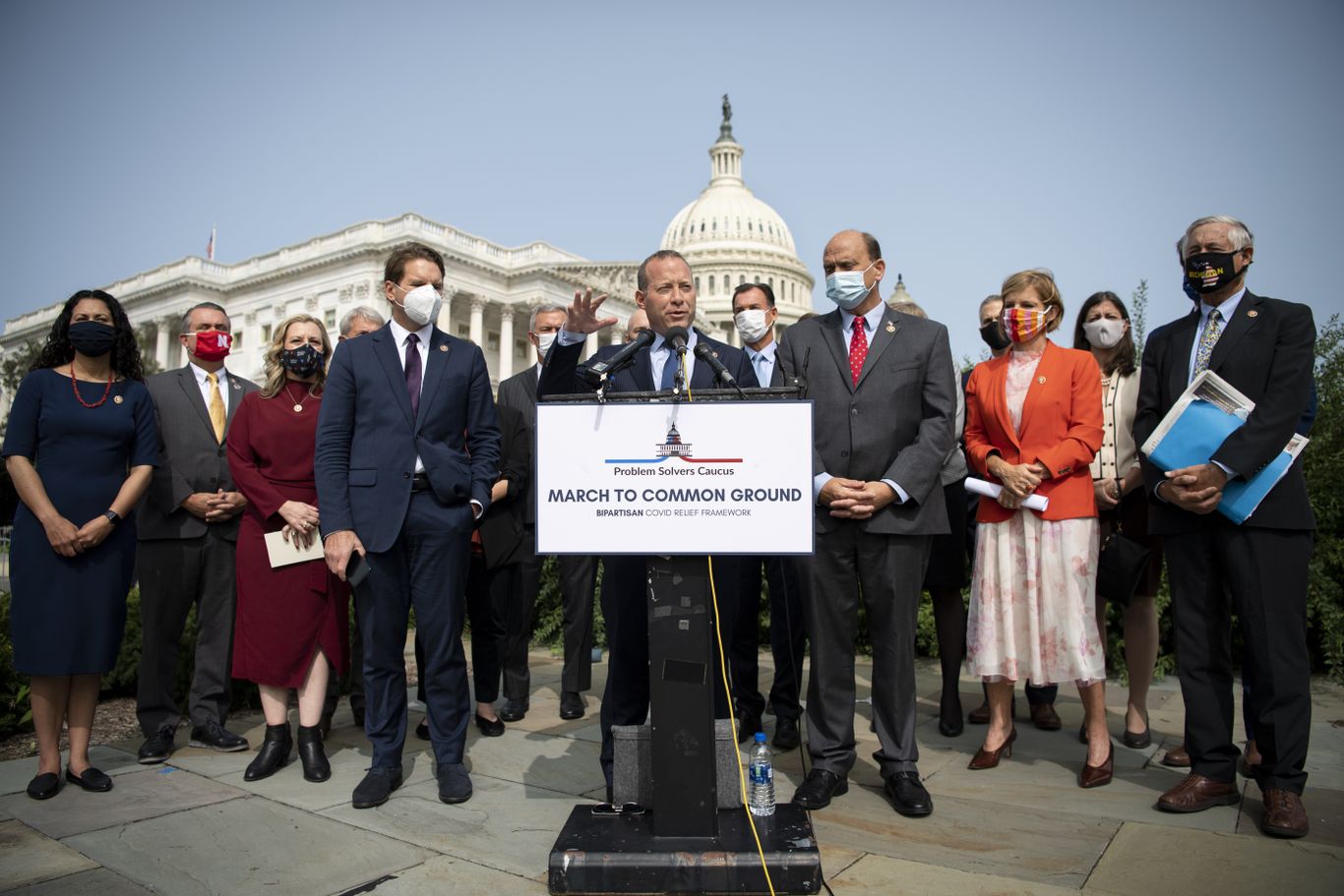 people speaking at an outdoor press conference in front of U.S. capitol