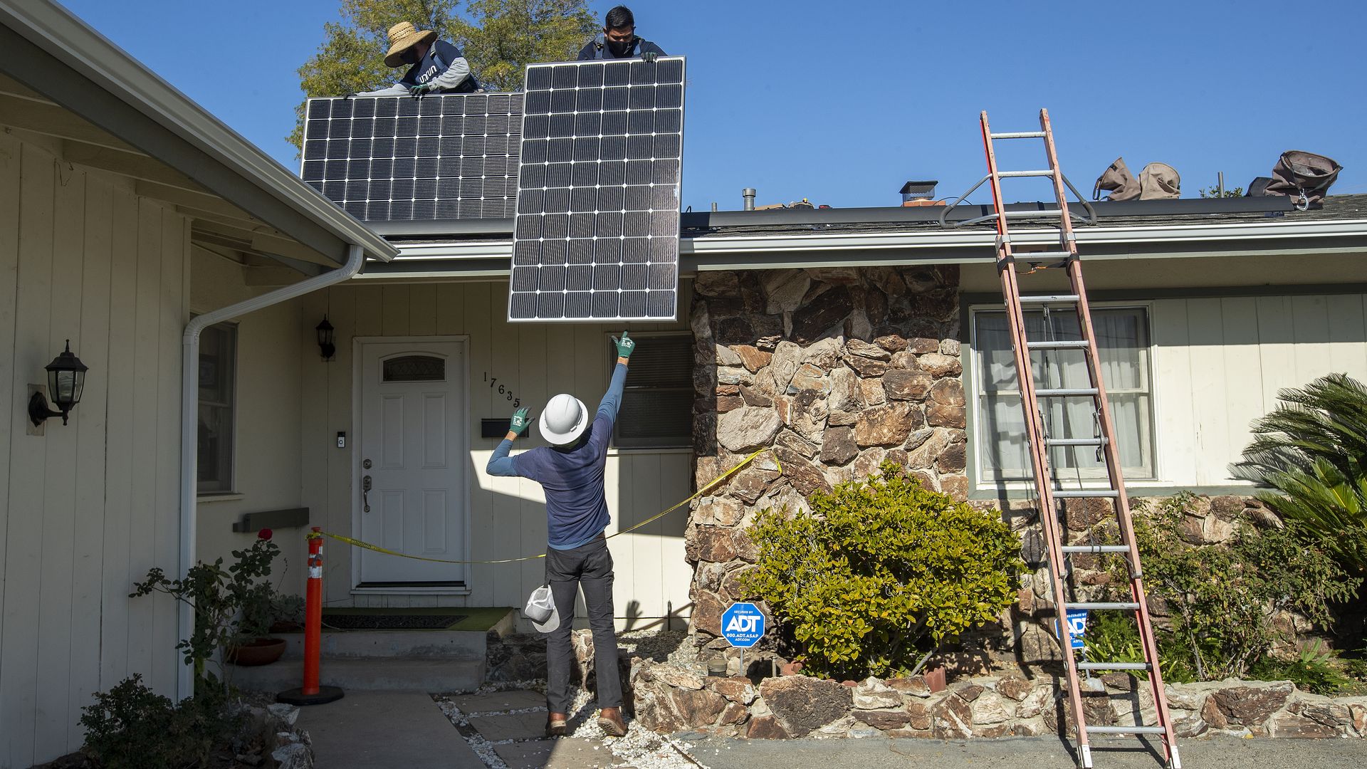 Photo of solar installers at work in California