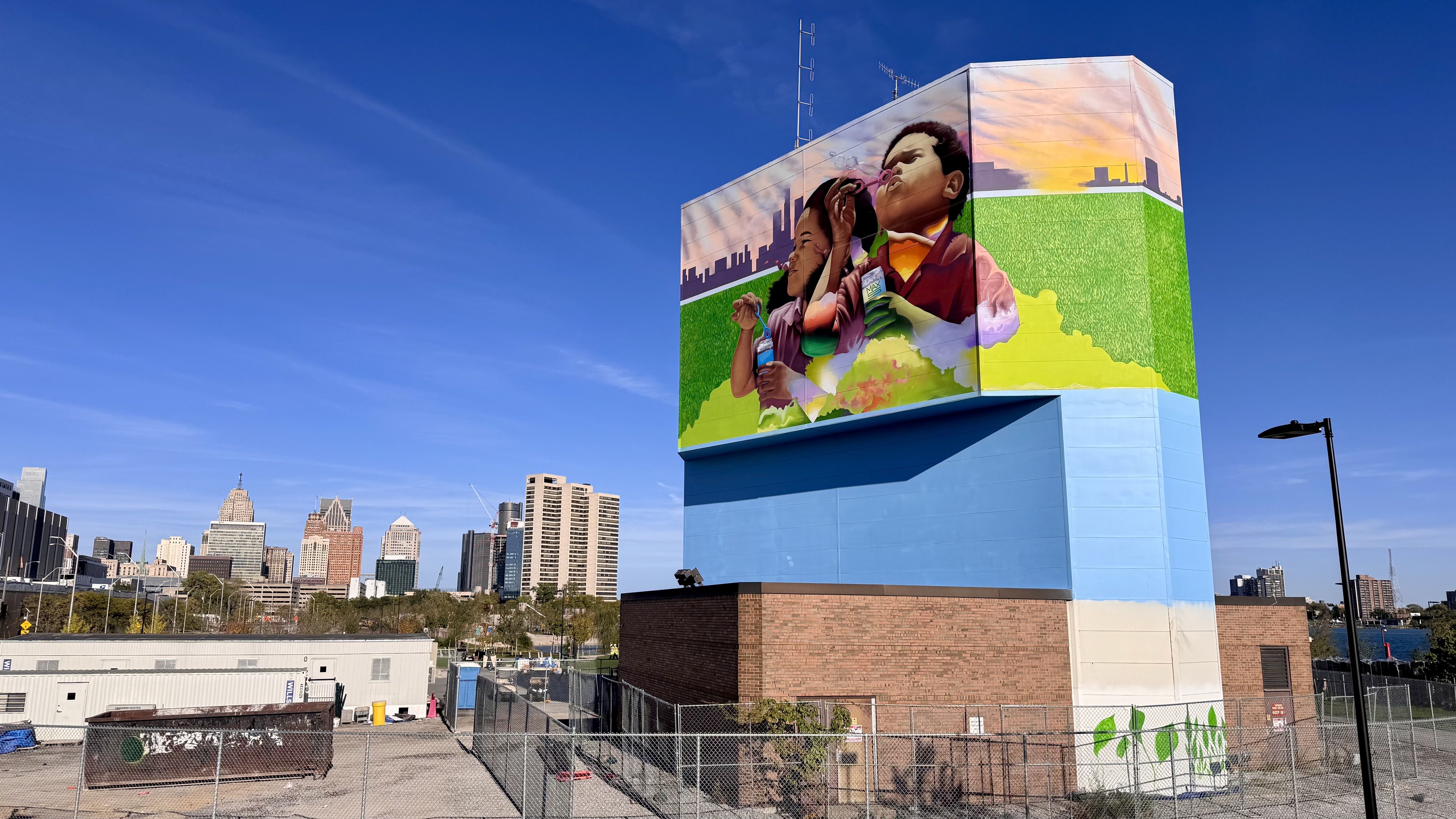 A mural of children with the skyline behind them