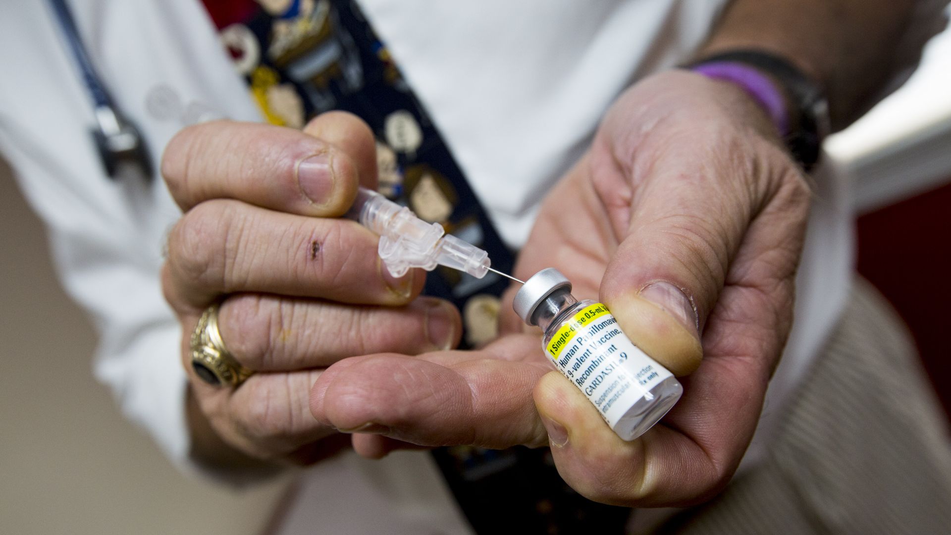 Pediatrician Richard K. Ohnmacht prepares a shot of the HPV vaccine Gardasil for a patient at his office in Cranston, Rhode Island, Sept. 3, 2015.
