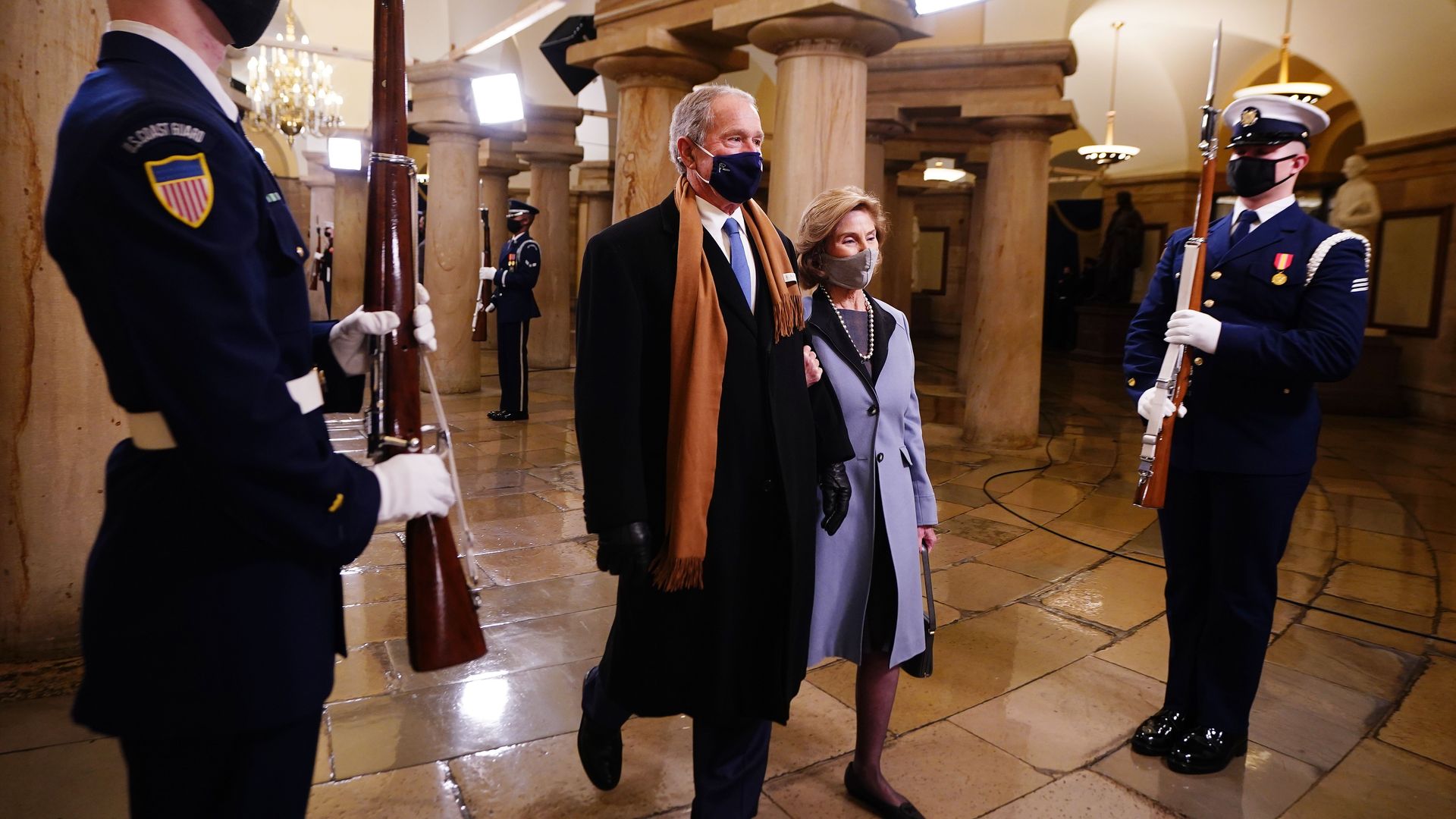 Photo of a masked George W. Bush and Laura Bush walking through the Capitol building