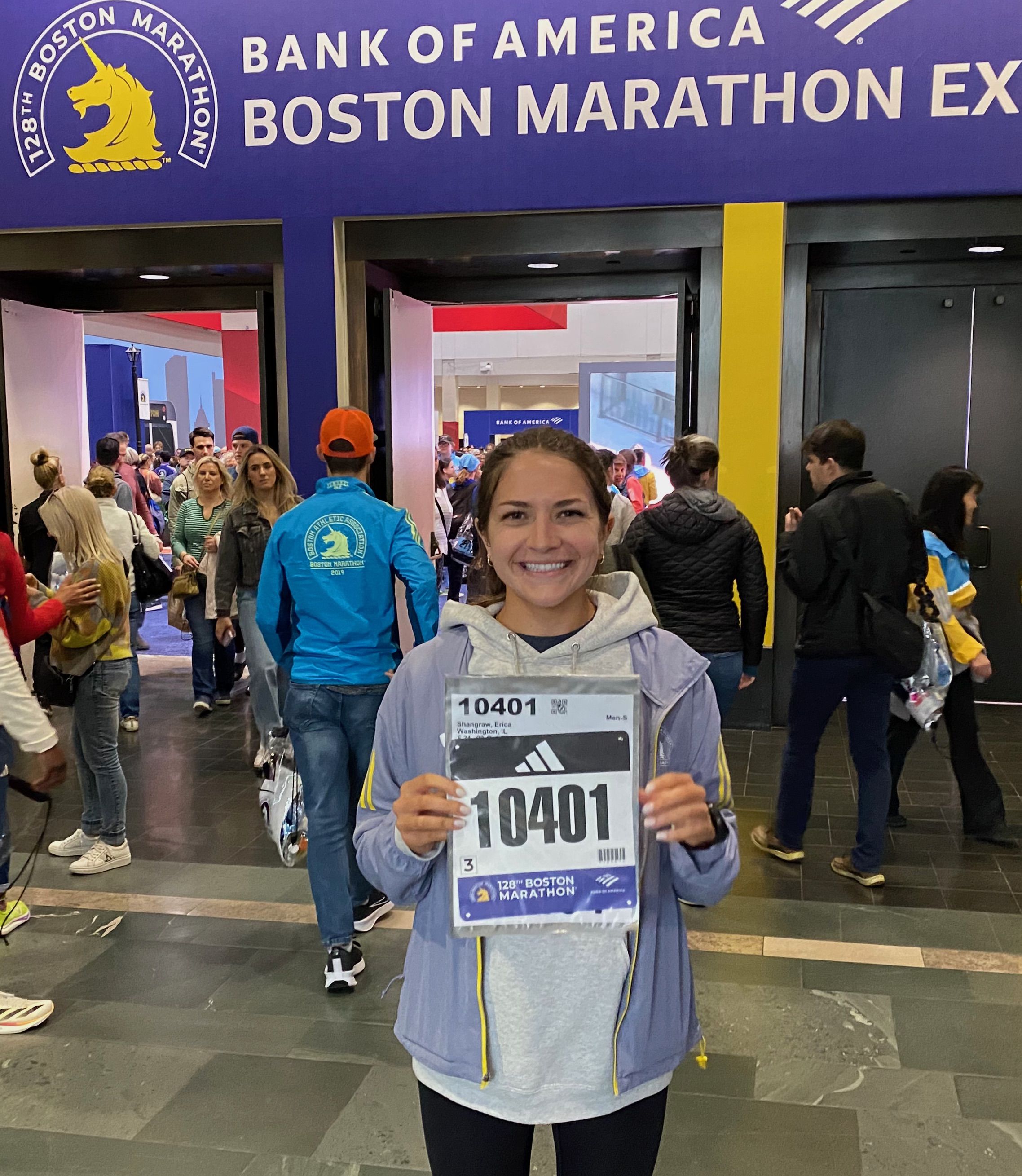 Erica Lynn holding her Boston Marathon bib at the 2024 Boston Marathon.