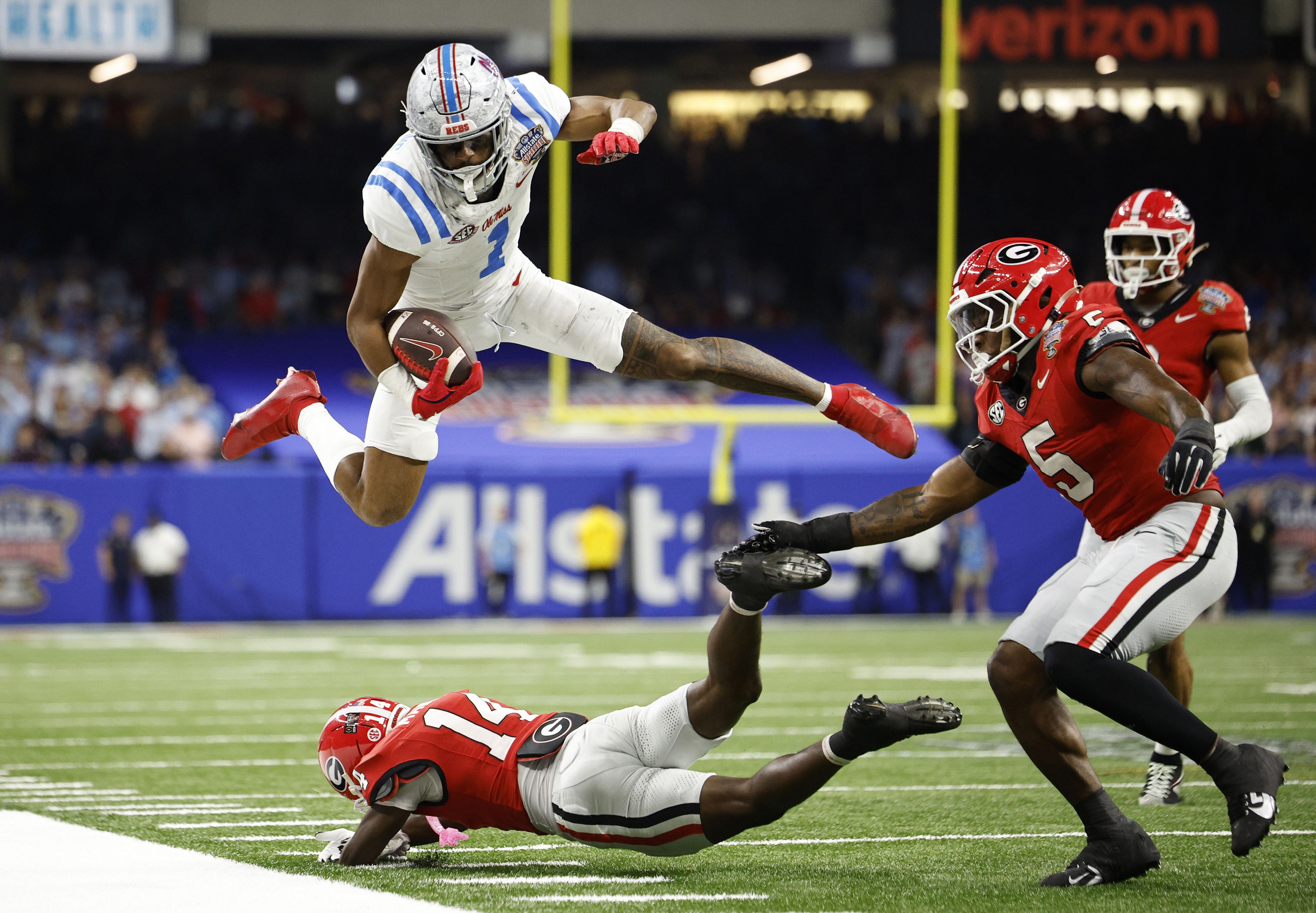 De'Zhaun Stribling #1 of the Ole Miss Rebels jumps over Adrian Maddox #14 of the Georgia Bulldogs during the fourth quarter during the 2025 College Football Playoff Quarterfinal at the Allstate Sugar Bowl at Caesars Superdome on January 01, 2026 in New Orleans, Louisiana.