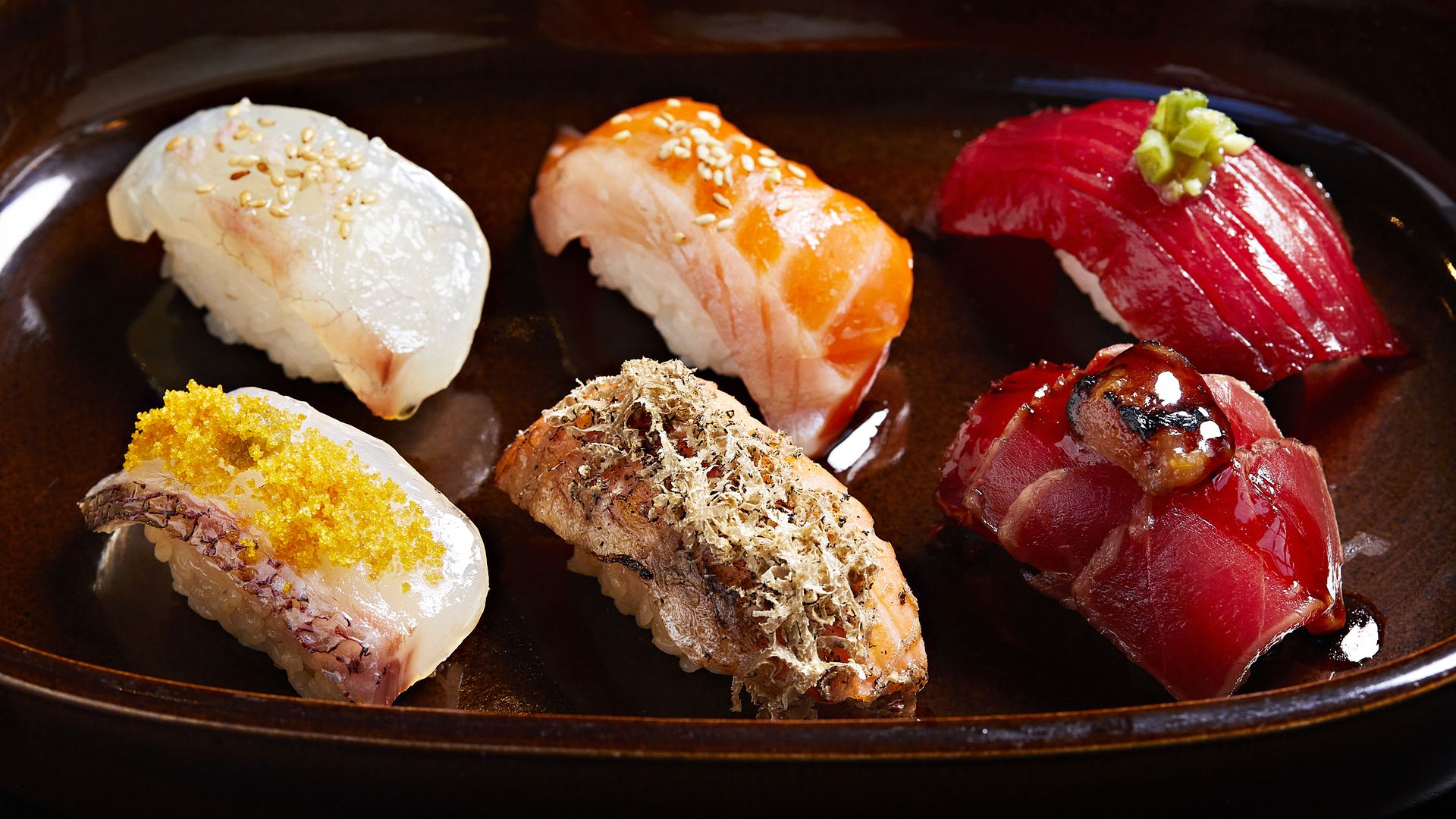 Top row from left to right: Tai snapper, konbu cured, sakura salt, Big Glory Bay salmon, Matsumae konbu, sesame, and Akami bluefin tuna, soy marinated with wasabi. Bottom row: New School Sushi - Tai snapper snapper with bottarga, white soy, Big Glory Bay salmon with truffle.
