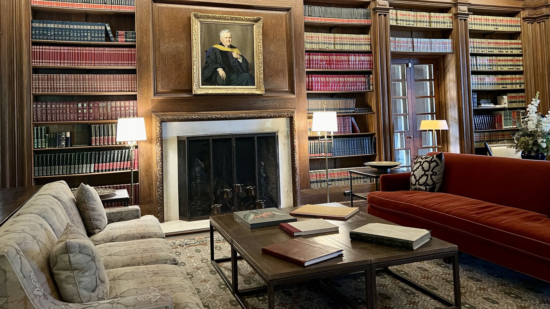 A library with books on shelves and two sofas facing each other