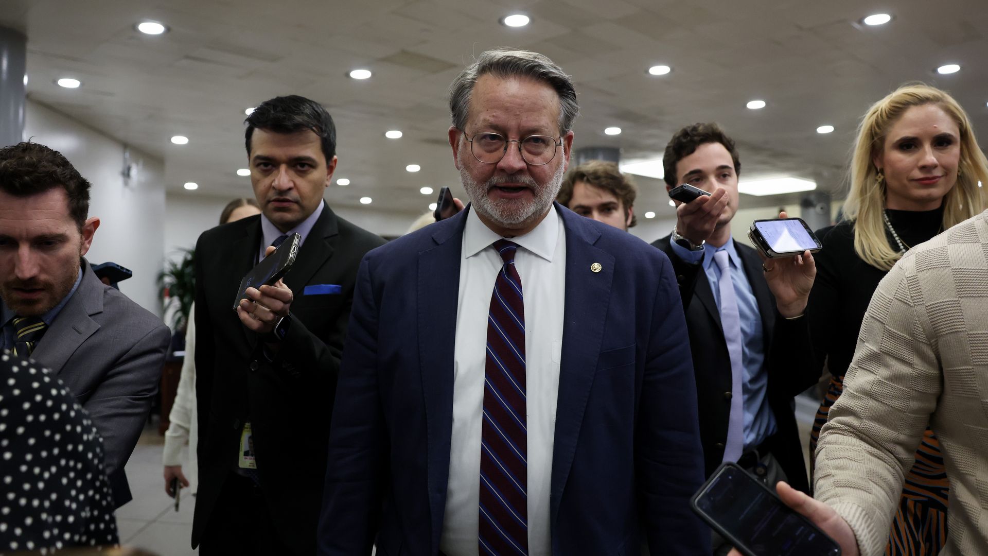 Sen. Gary Peters (D-MI) talks to reporters on his way to a procedural vote 