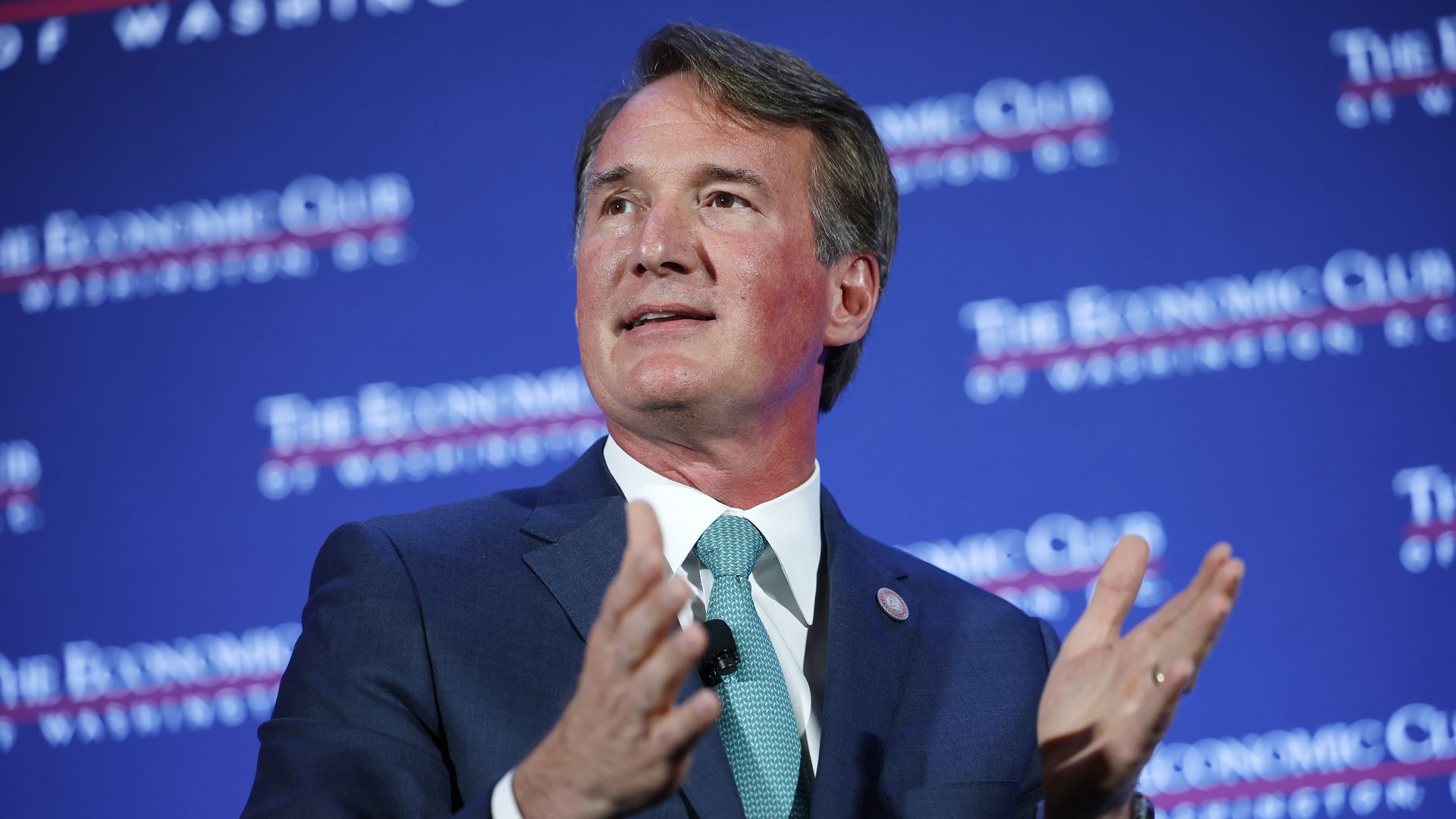 Virginia Gov. Glenn Youngkin is shown wearing a blue suit and a green tie.