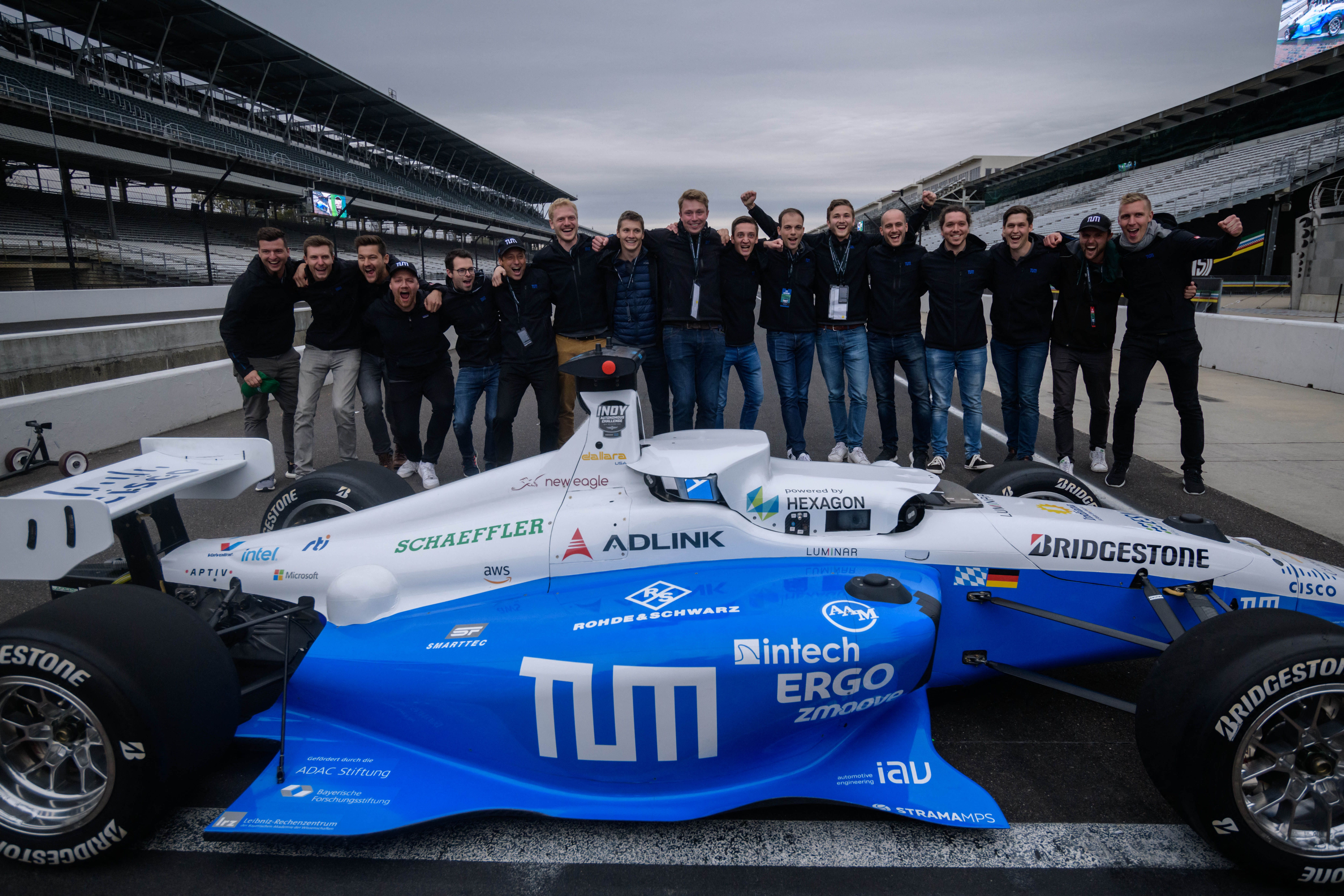  Team members of TUM Autonomous Motorsport pose for photos after winning the Indy Autonomous Challenge race at the Indianapolis Speedway in Indianapolis on October 23