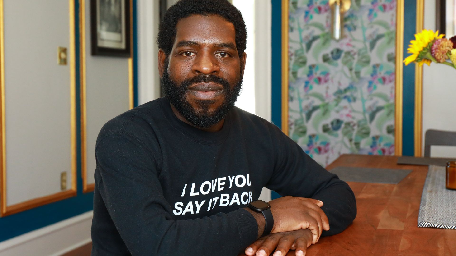 Author Hanif Abdurraqib is seated at a table. 