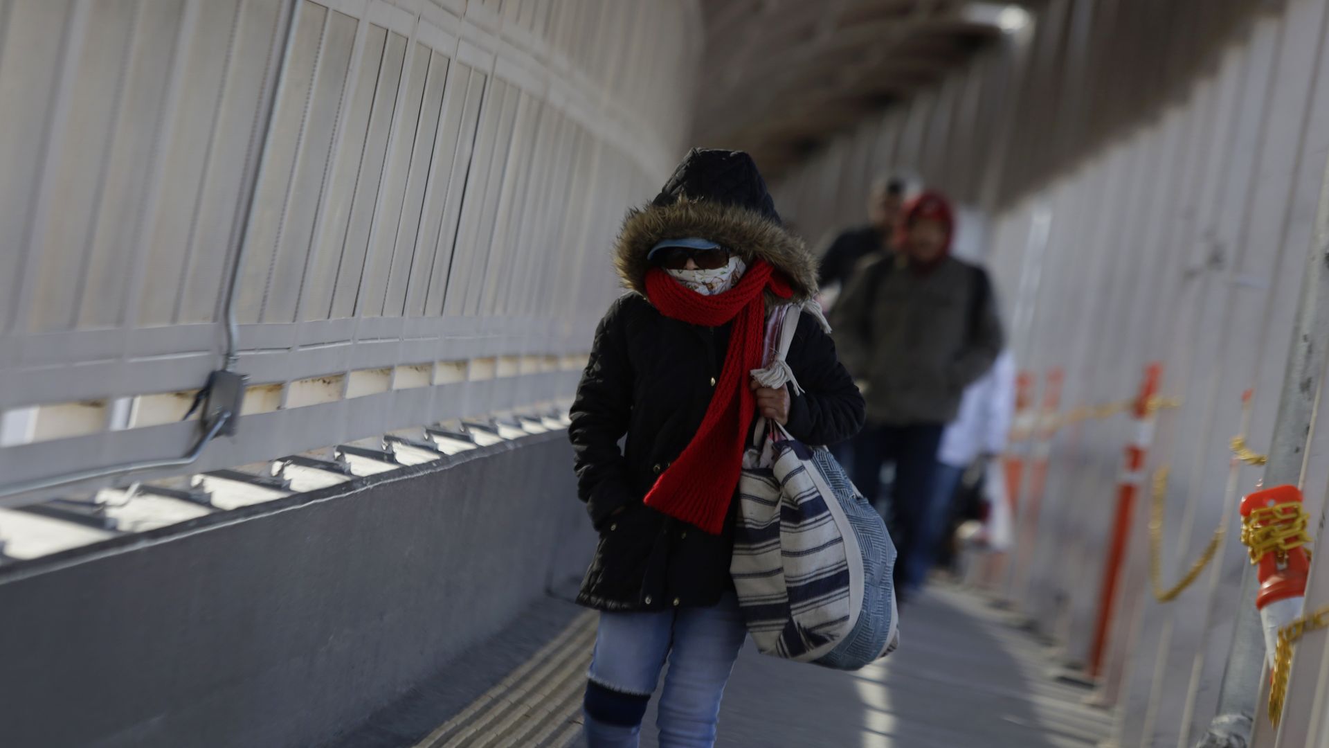 Pedestrians cross at the entrance to the Paso del Norte International Bridge in Ciudad Juarez, Mexico, on February 1, 2025, where North American authorities carry out mass deportations of migrants handed over to personnel from Mexico's National Migration Institute. 