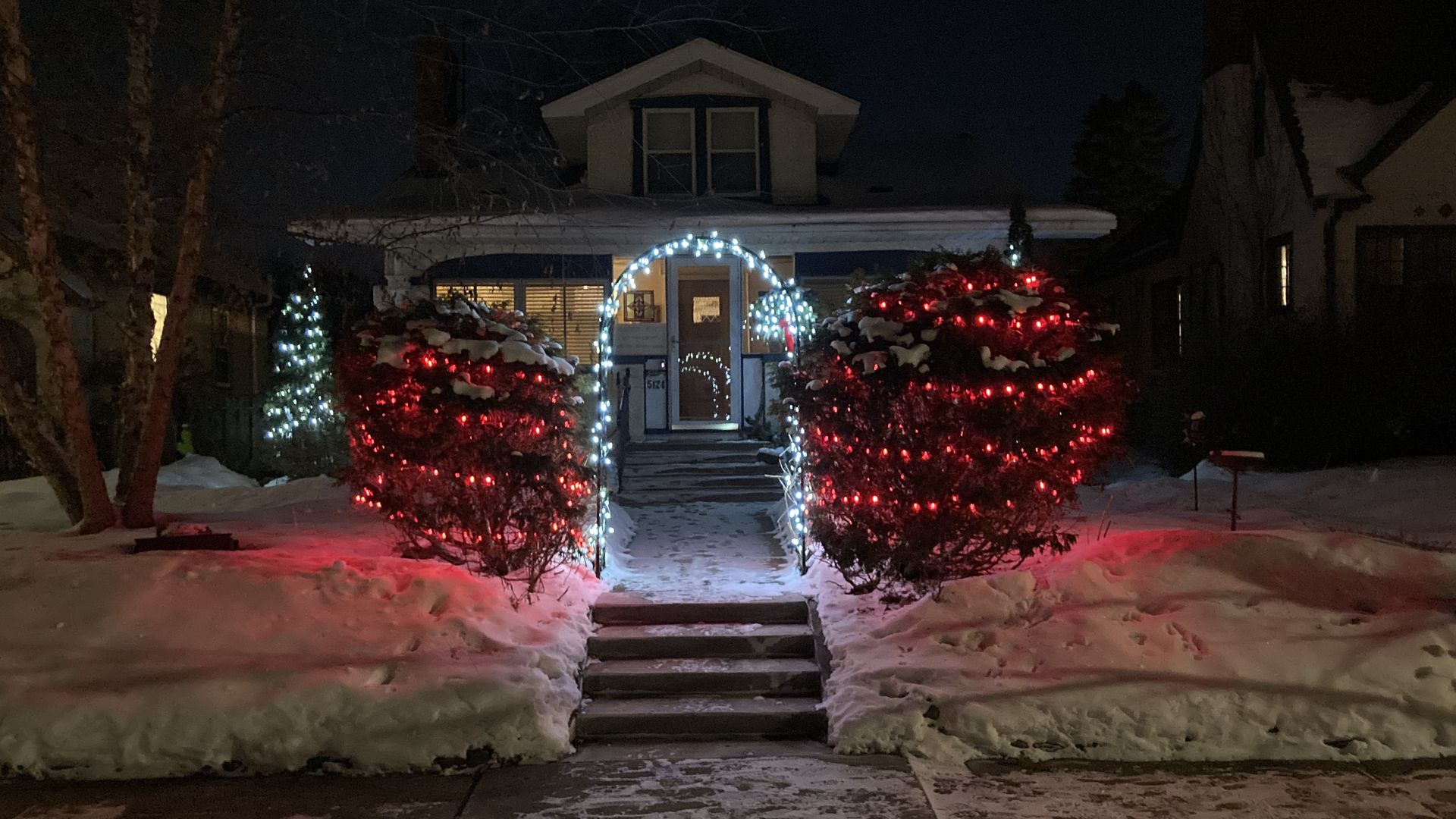 A home in Minneapolis with Christmas lights glowing in the front yard