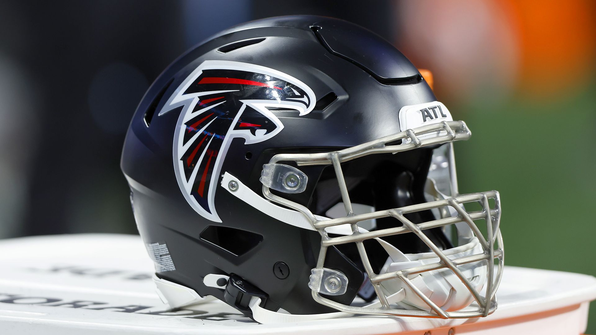 An Atlanta Falcons football helmet sits on the sidelines