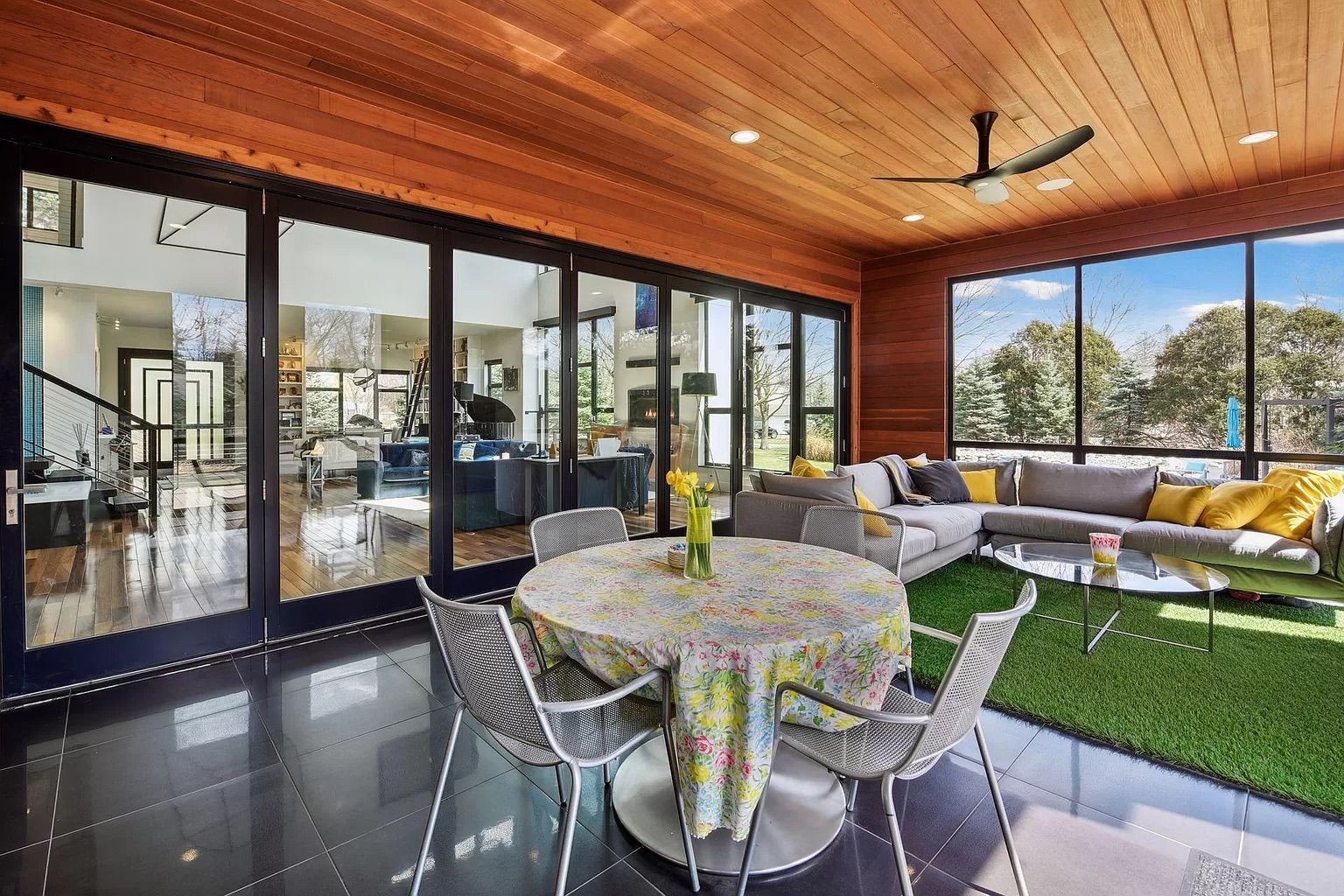 A screened-in porch with glass walls.