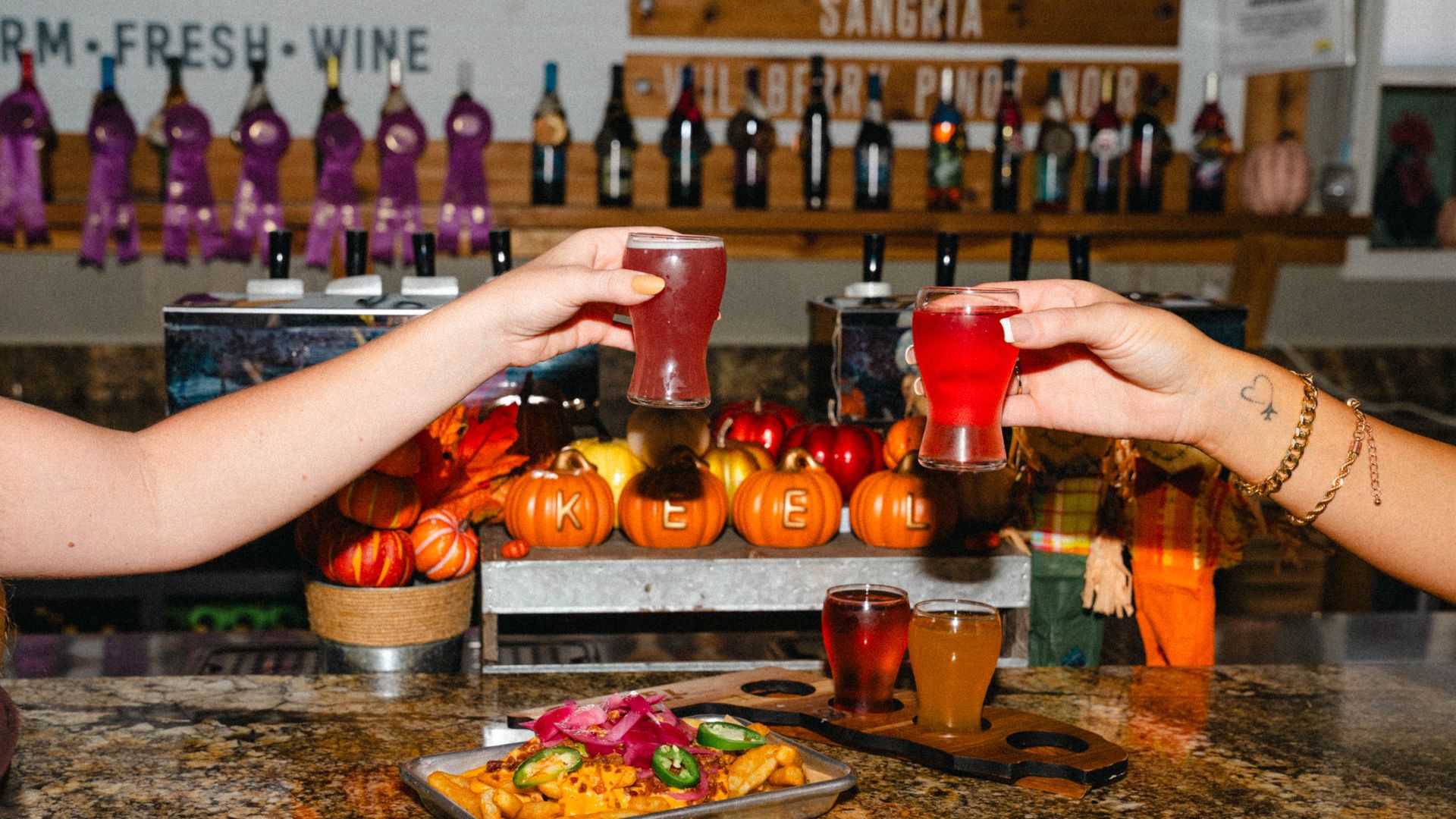 Hands cheersing togther glasses of fall cider.