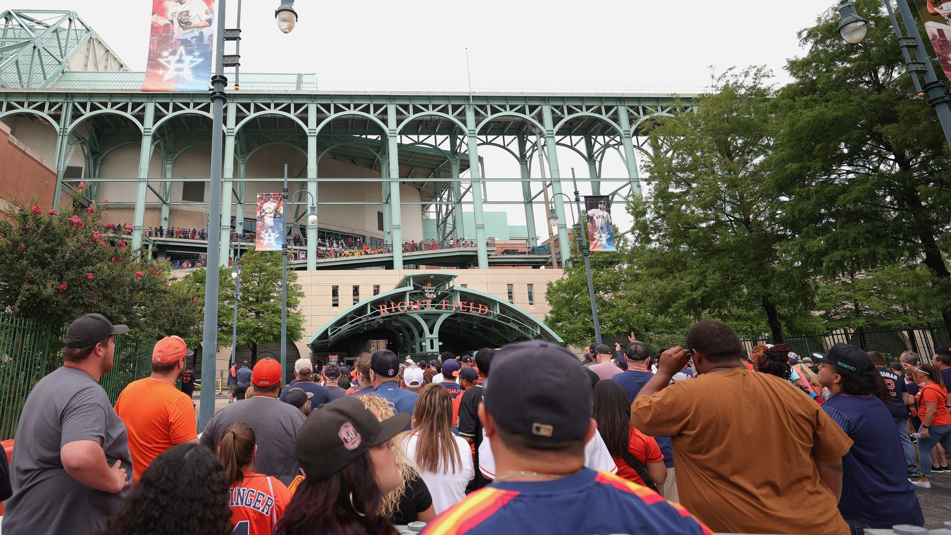 people stand outside Minute Maid Park