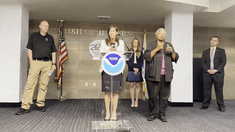 Image shows people talking on stage.