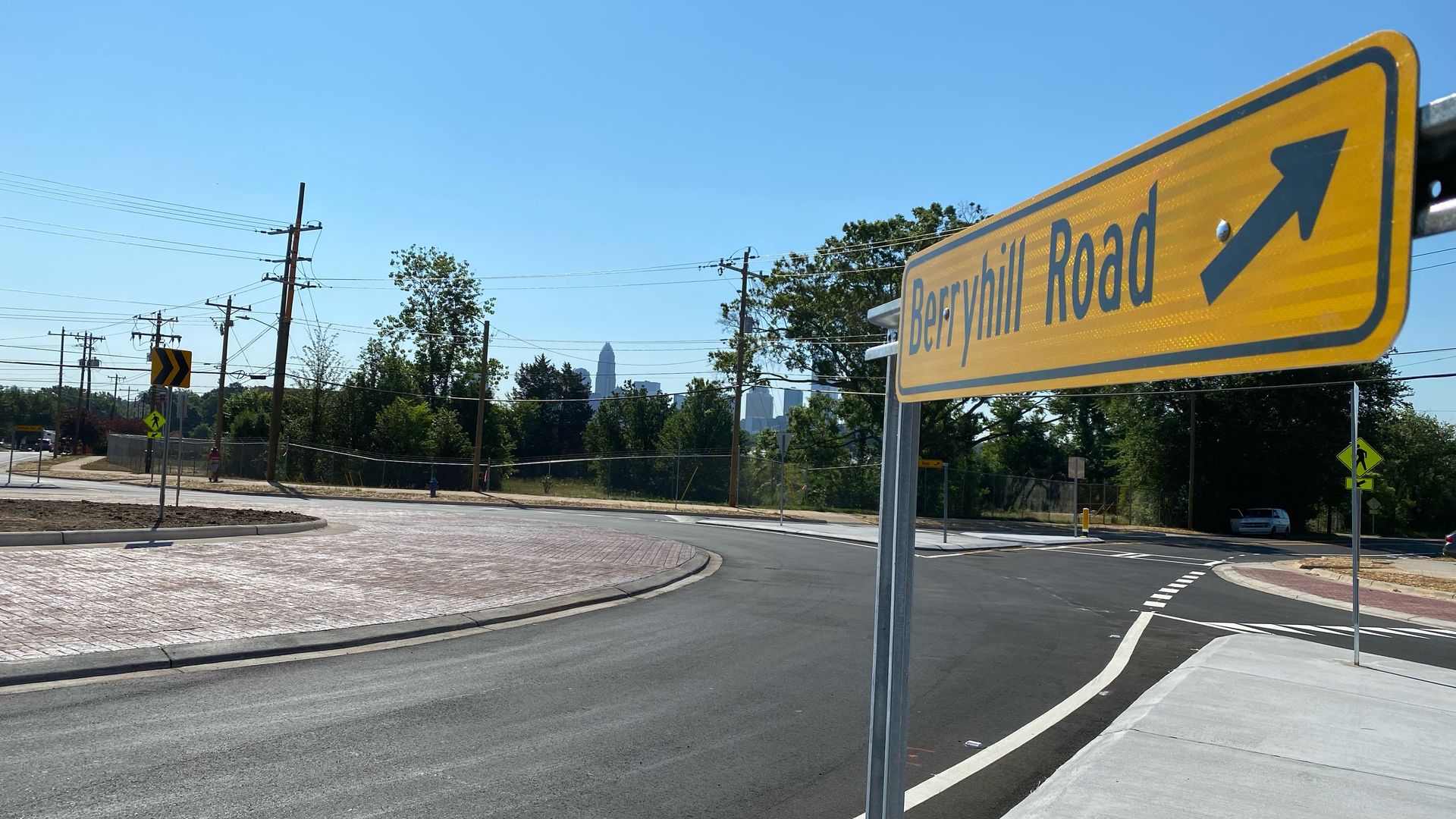 sign at a roundabout that reads "Berryhill Road" with an arrow pointing toward the camera