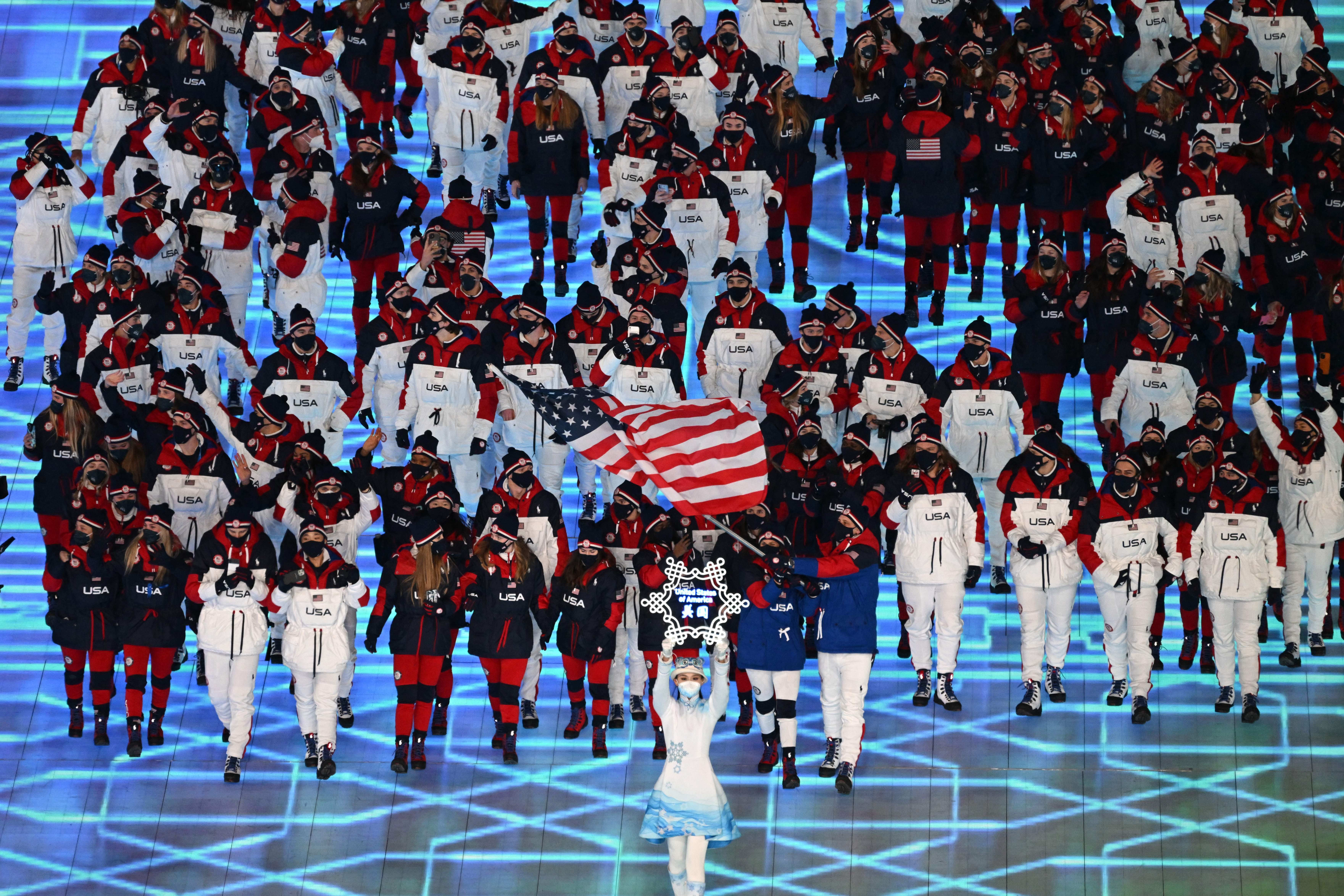 USA's flag bearers John Shuster and Elana Meyers Taylor lead the delegation as they enter the stadium.