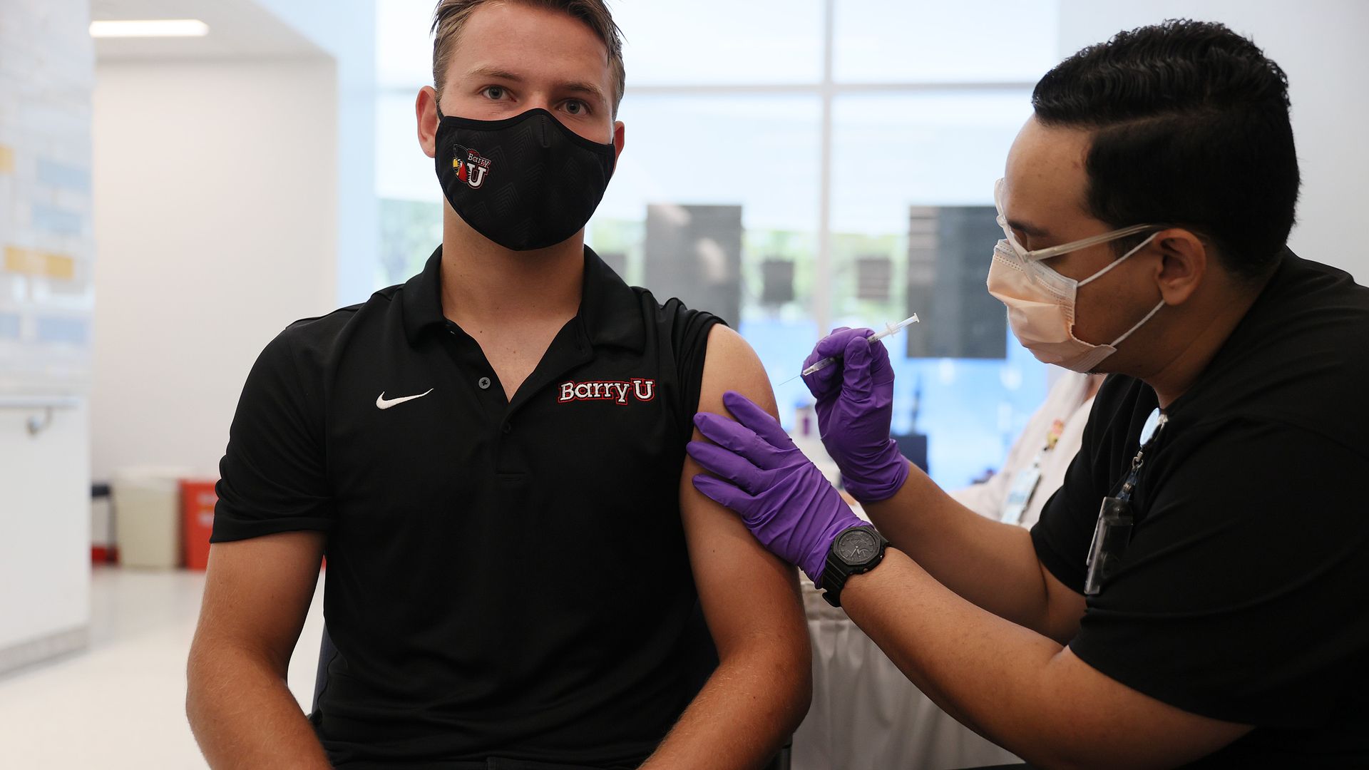 A man receives a shot of the Pfizer coronavirus vaccines