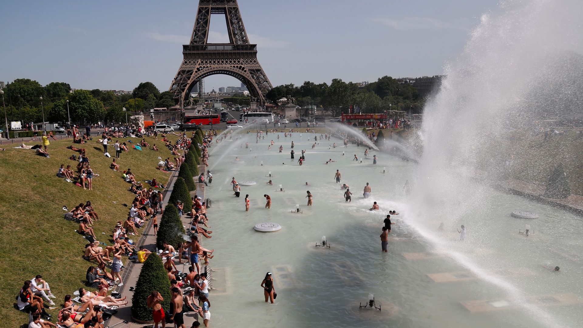 People bathe in the Trocadero Fountain near the Eiffel Tower in Paris during a heatwave on June 28.