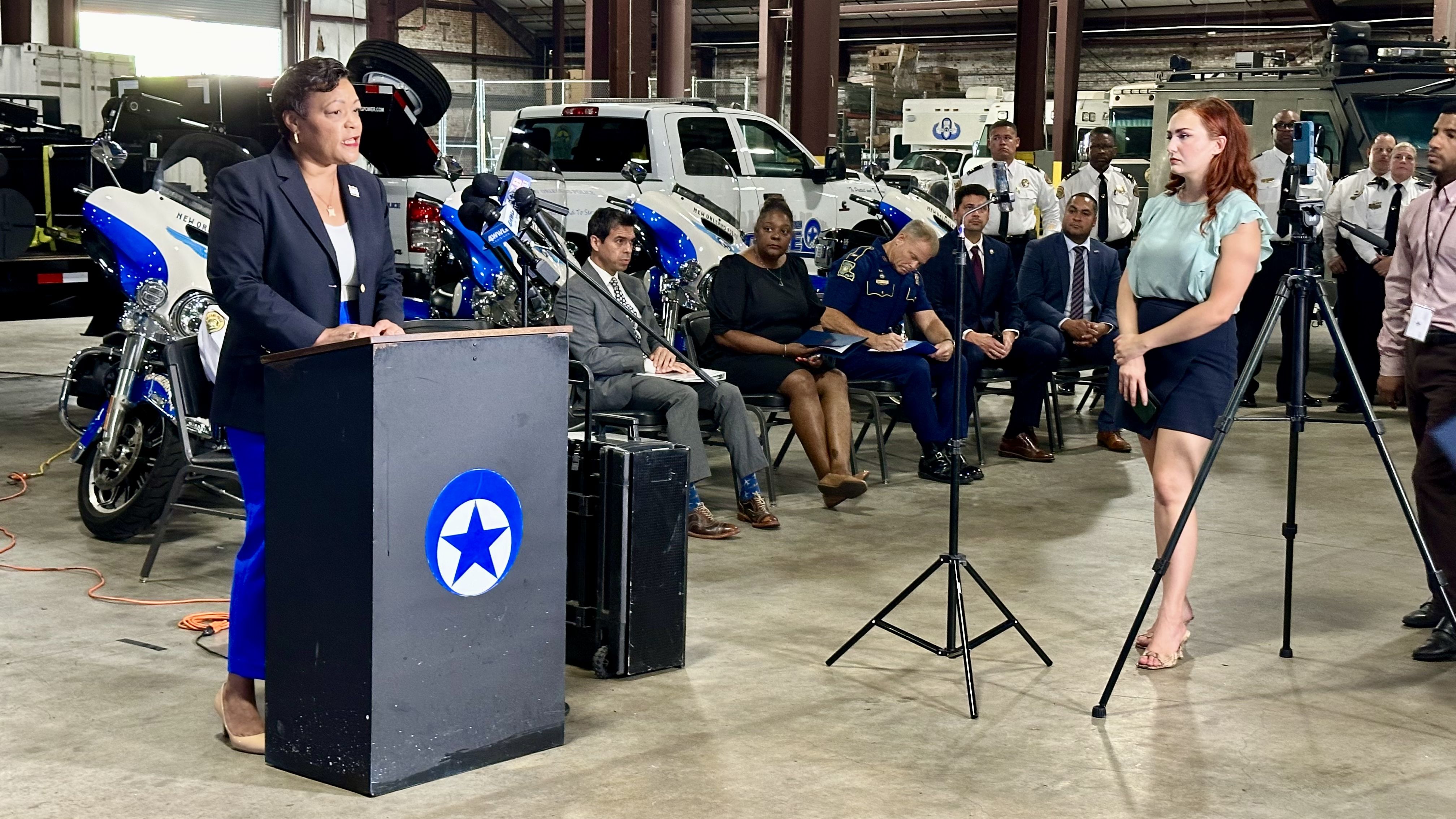 Photo shows Mayor LaToya Cantrell talking at a podium.