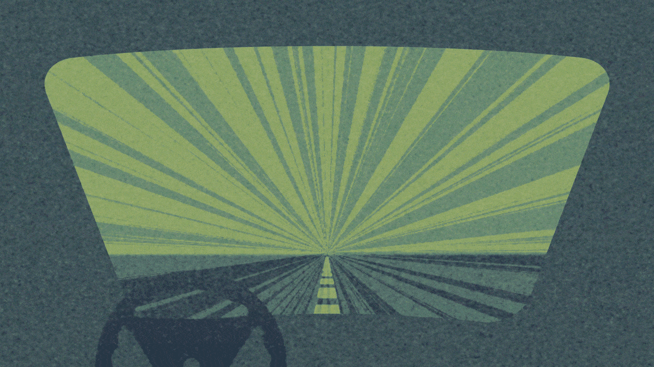 Animated illustration of a windshield view from a car moving down a street, passing the words DRIVE and THRU.